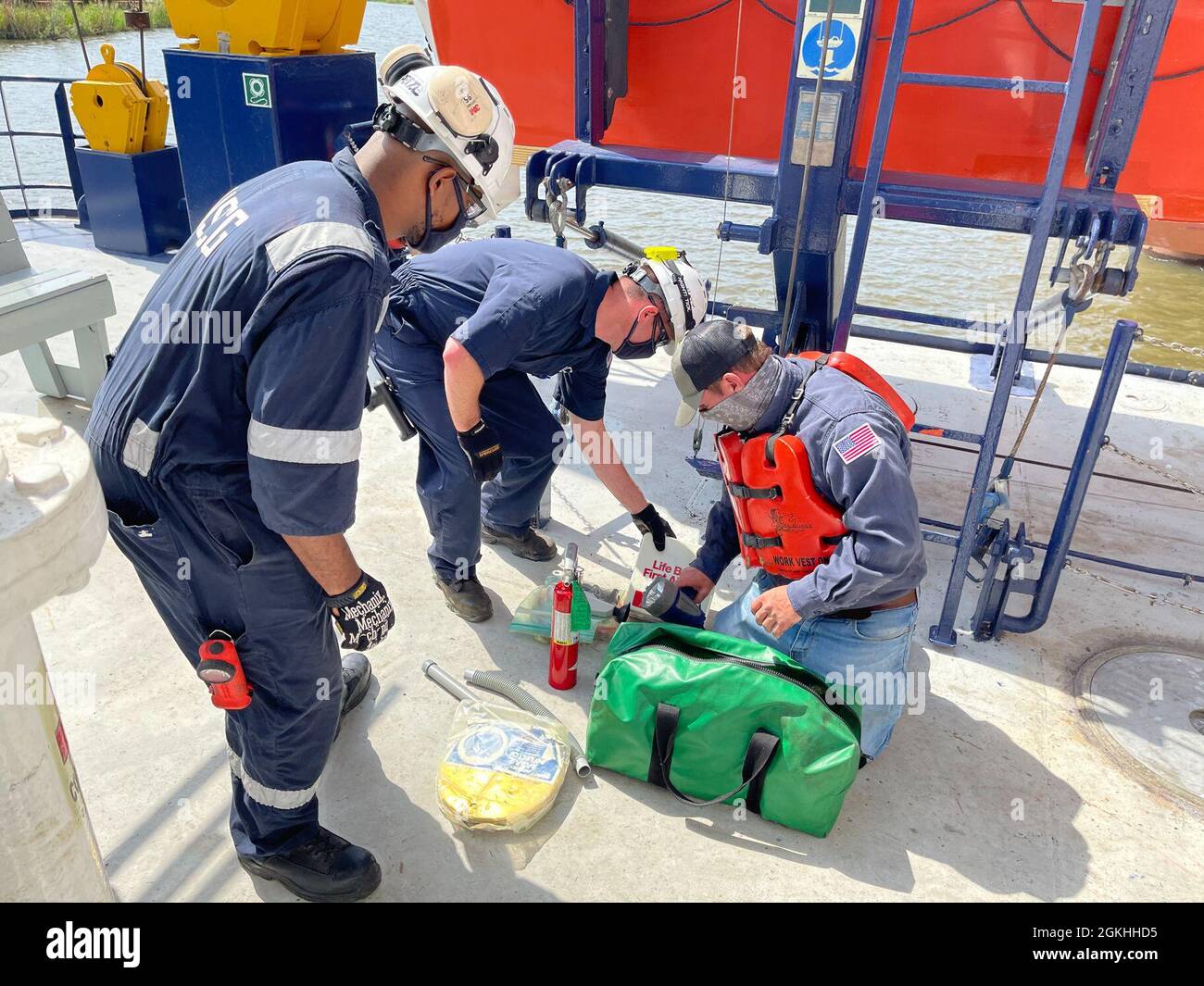 Coast Guard Marine Inspectors and a SEACOR Eagle crew member verify all the gear needed for the small boat onboard the lift vessel in Houma, Louisiana, April 23, 2021. The crew and vessel was inspected by Coast Guard marine inspectors for readiness and approval to be used as an asset for the SEACOR Power response. Stock Photo