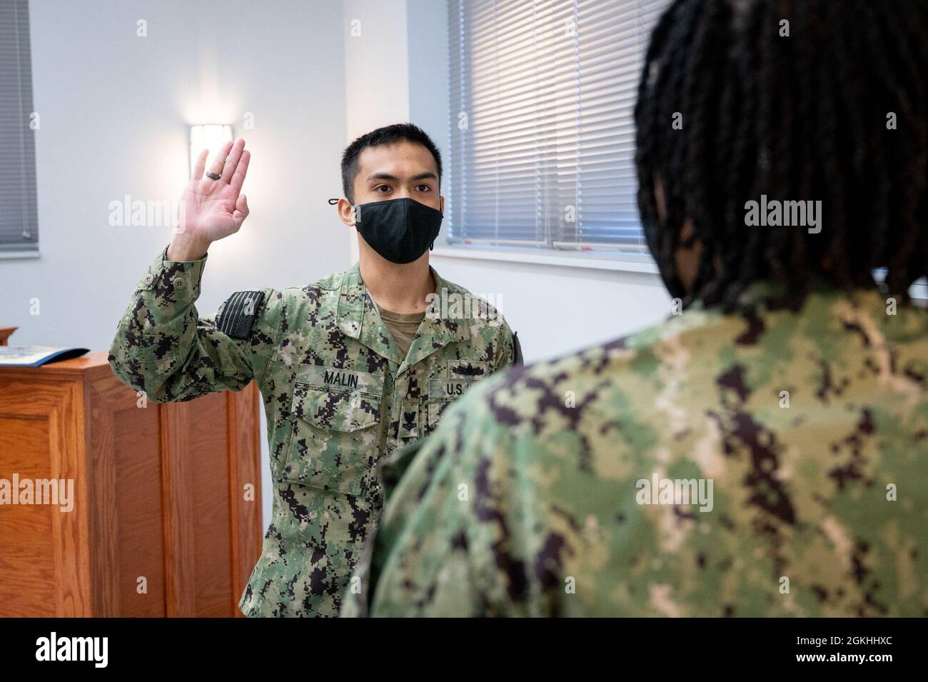 WASHINGTON, DC (April 23, 2021) – Religious Program Specialist 2nd Class Arvin Malin recites the oath of enlistment during a ceremony onboard Washington Navy Yard. Stock Photo