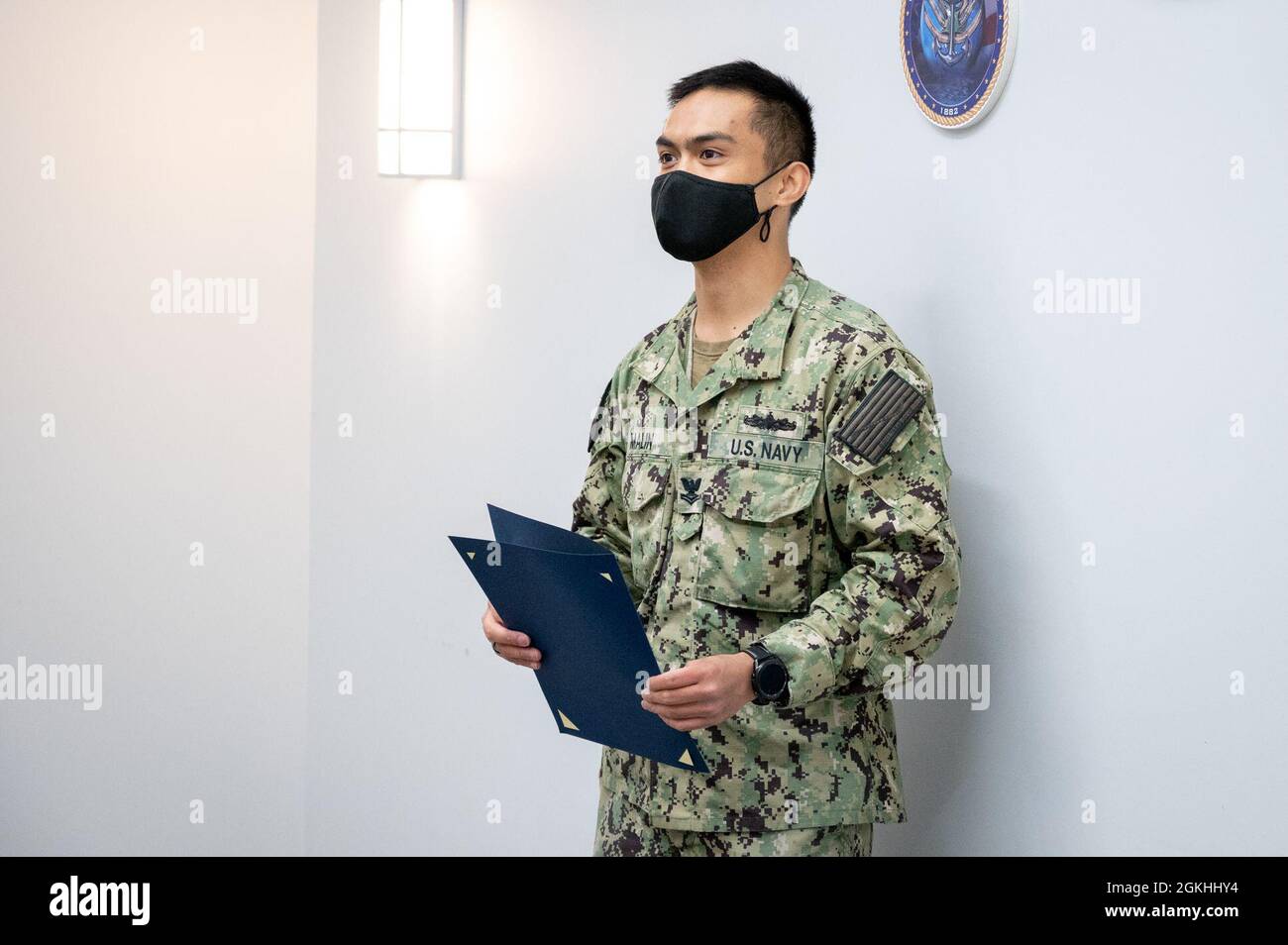 WASHINGTON, DC (April 23, 2021) – Religious Program Specialist 2nd Class Arvin Malin listens to remarks during his reenlistment ceremony onboard Washington Navy Yard. Stock Photo