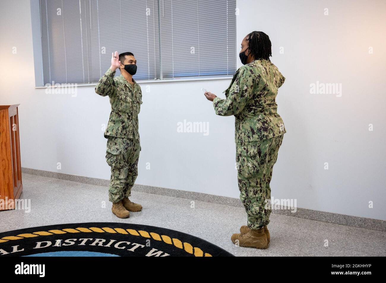 WASHINGTON, DC (April 23, 2021) – Religious Program Specialist 2nd Class Arvin Malin, left, recites the oath of enlistment during a ceremony onboard Washington Navy Yard. Stock Photo