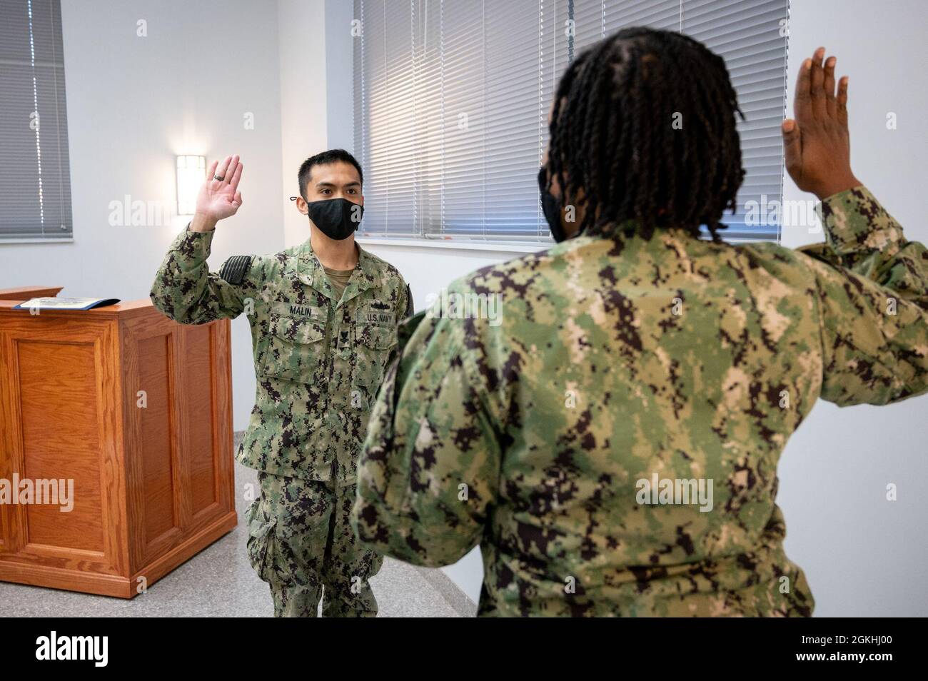 WASHINGTON, DC (April 23, 2021) – Religious Program Specialist 2nd Class Arvin Malin recites the oath of enlistment during a ceremony onboard Washington Navy Yard. Stock Photo