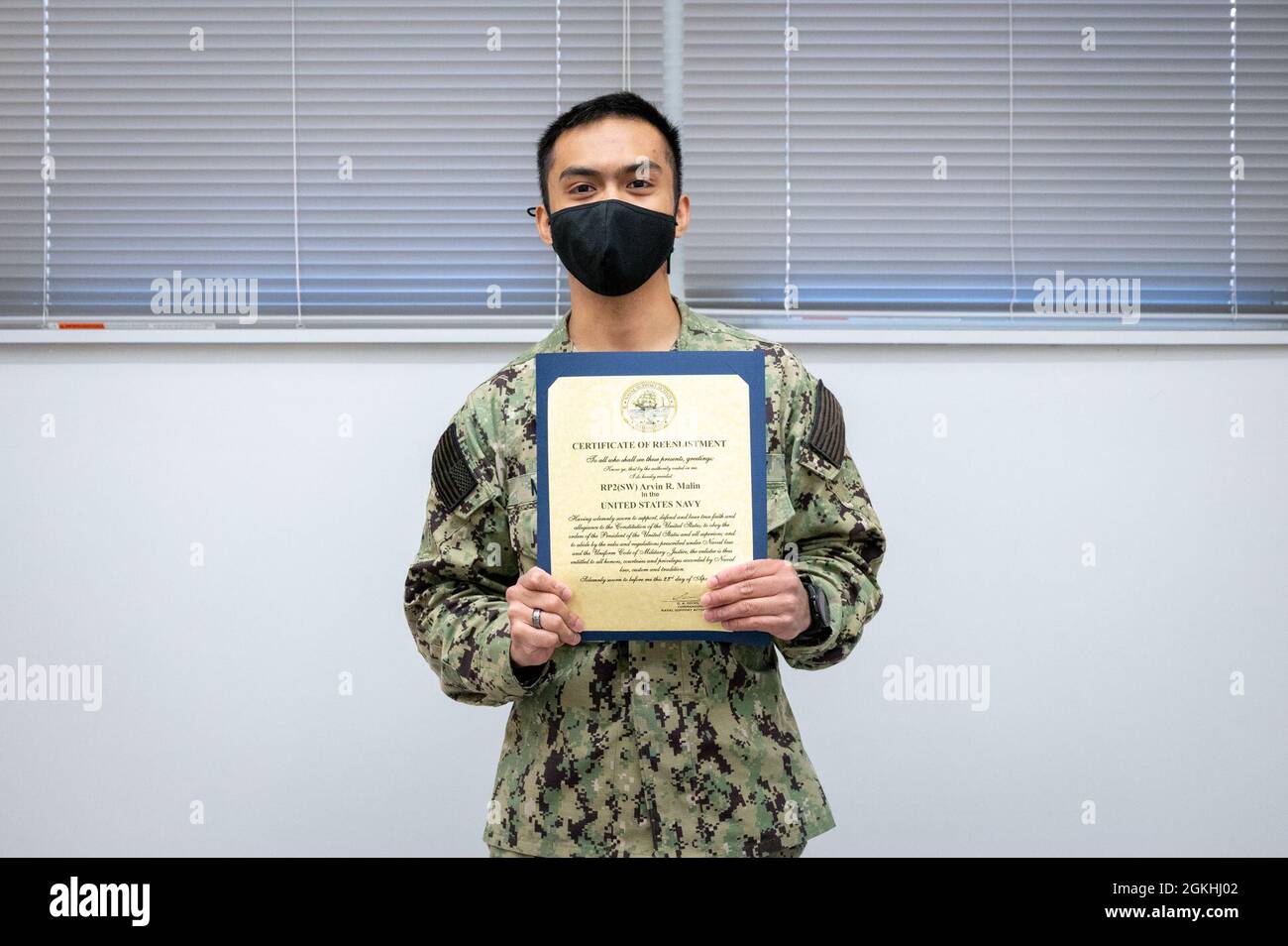 WASHINGTON, DC (April 23, 2021) – Religious Program Specialist 2nd Class Arvin Malin poses with his certificate of enlistment during a ceremony held onboard Washington Navy Yard. Stock Photo
