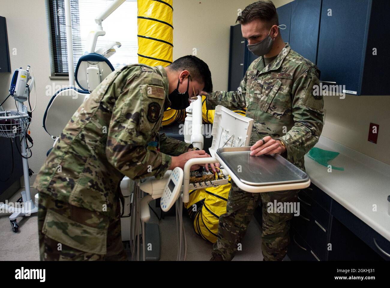 U.S. Air Force Airman 1st Class Eric Perez-Solano, 375th Medical Support  Squadron biomedical equipment technician, and Airman 1st Class Sky Gauvin,  137th Aeromedical Evacuation Squadron biomedical equipment technician,  repair a dental chair