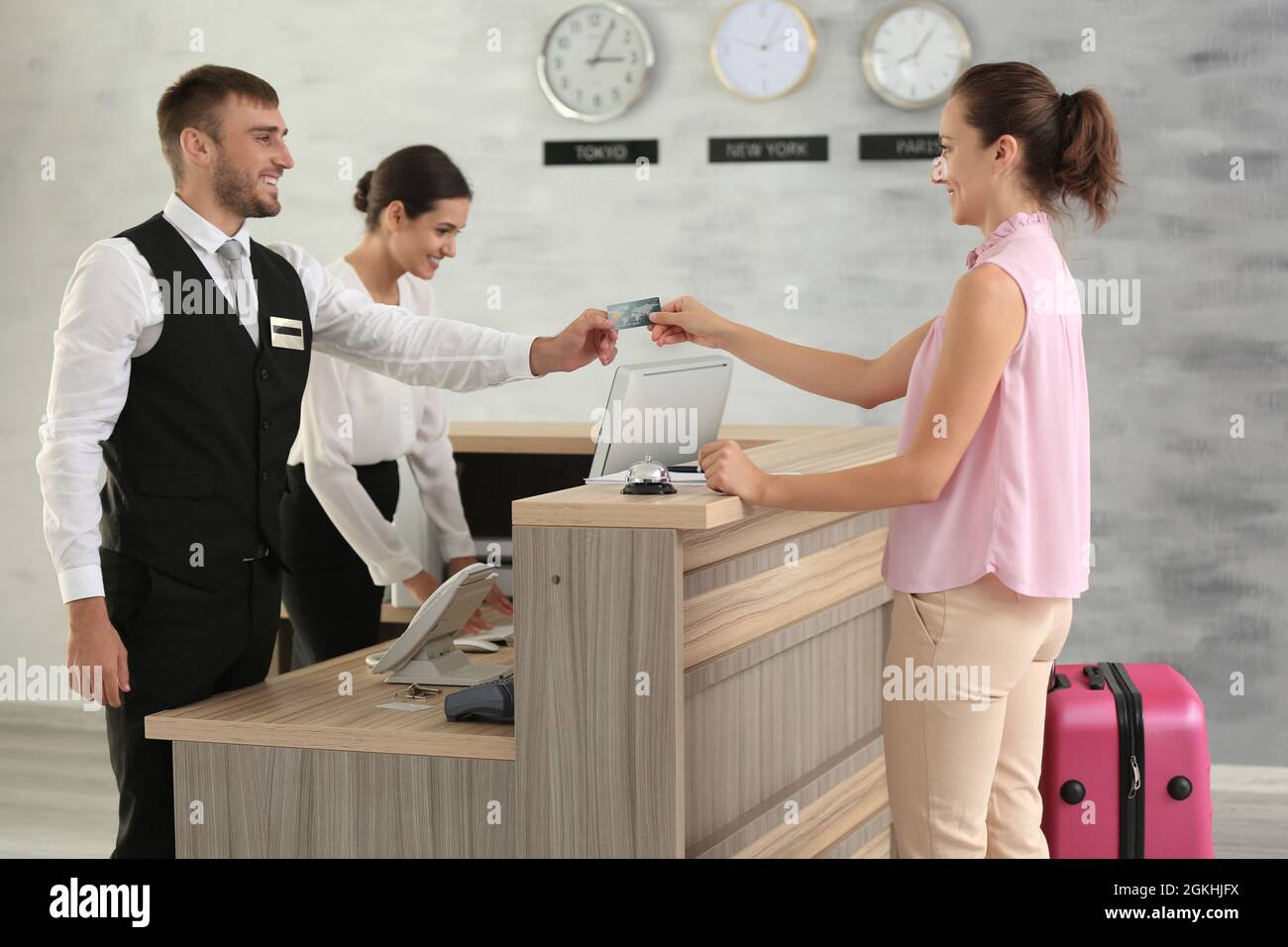 Woman paying for hotel room at reception Stock Photo Alamy