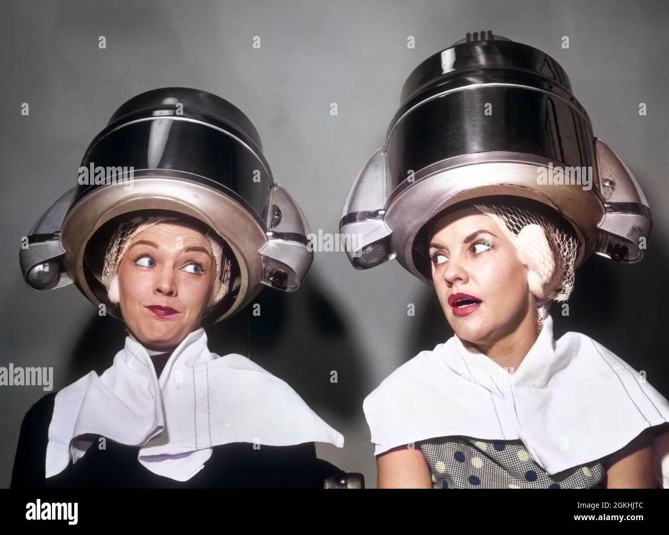 1950s TWO WOMEN GOSSIPING SITTING TOGETHER UNDER HAIR DRYERS IN HAIRDRESSER SALON - s8919c DEB001 HARS COMIC SALON NET BEST LIFESTYLE LISTEN FEMALES GOSSIP RELATION STUDIO SHOT HEAT COPY SPACE FRIENDSHIP HALF-LENGTH VANITY SIBLINGS AMERICANA SISTERS GOSSIPING B&W BUZZ WEIRD NETWORKING ZANY GLANCE TELLING UNCONVENTIONAL SCANDAL CANDID FEMININE SIBLING DOME NEIGHBOR DRYERS HAIR DRYER BEAUTY PARLOR DISAPPROVAL PARLOR RUMOR STYLISH TELL BEST FRIEND DEB001 IDIOSYNCRATIC BEAUTY SALON HAIR NET PERMANENT WAIT AMUSING ECCENTRIC GOSSIPY HAIR DRESSER HAIRDO MID-ADULT MID-ADULT WOMAN PEOPLE ADULTS RUMORS Stock Photo