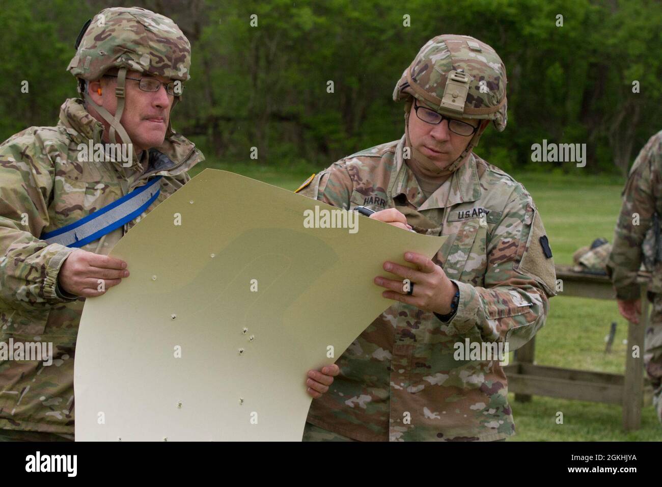 U.S. Army Reserve Sgt. First Class Joel Quebec and Capt. Richard Harris attached to the 367th Mobile Public Affairs Detachment, grade Harris' M-9 pistol scorecard at Camp Sherman Joint Training Center, Chillcothe, Ohio, April 24, 2021. The scorecard for each Soldier must be tallied at the end of the final firing table. Stock Photo