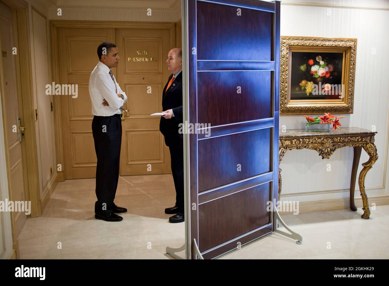 President Barack Obama talks with National Security Advisor Tom Donilon in the hallway outside his hotel suite in Santiago, Chile, March 21, 2011. (Official White House Photo by Pete Souza) This official White House photograph is being made available only for publication by news organizations and/or for personal use printing by the subject(s) of the photograph. The photograph may not be manipulated in any way and may not be used in commercial or political materials, advertisements, emails, products, promotions that in any way suggests approval or endorsement of the President, the First Family, Stock Photo