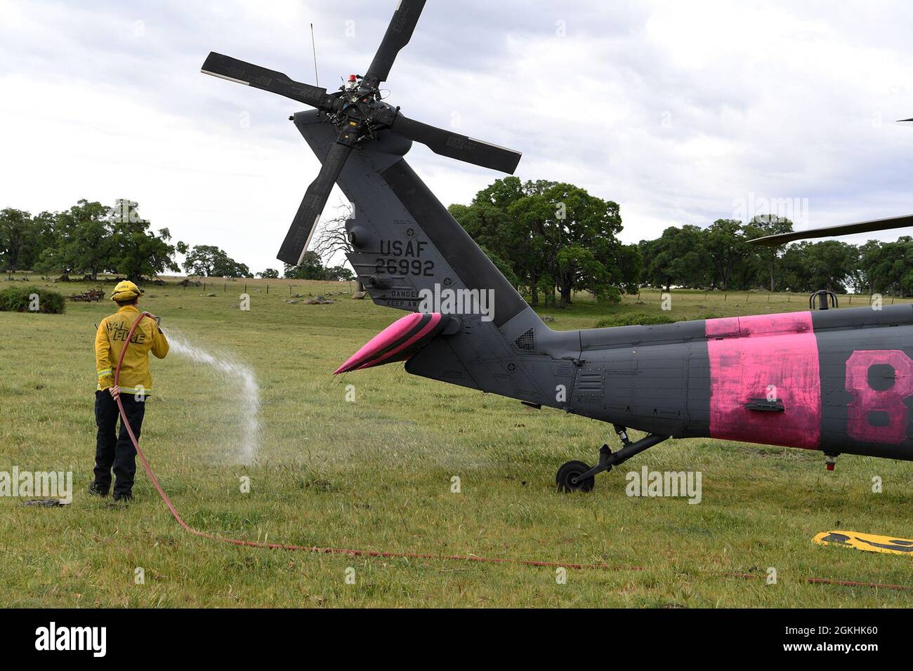 A CAL FIRE firefighter sprays water around a California Air National ...