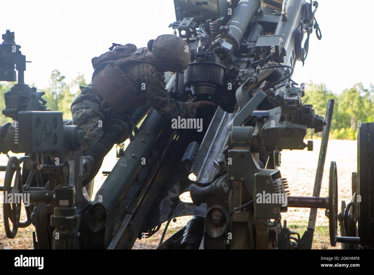 U.S. Marine Corps Lance Cpl. Khamryn Cruz, a native of Talofofo, Guam, and a field artillery cannoneer with 1st Battalion, 10th Marine Regiment, 2d Marine Division (2d MARDIV), cleans a M777 Howitzer during Exercise Rolling Thunder 21.2 on Fort Bragg, N.C., April 25, 2021. This exercise is a 10th Marine Regiment-led live-fire artillery event that tests 10th Marines' abilities to operate in a simulated littoral environment against a peer threat in a dynamic and multi-domain scenario. Stock Photo