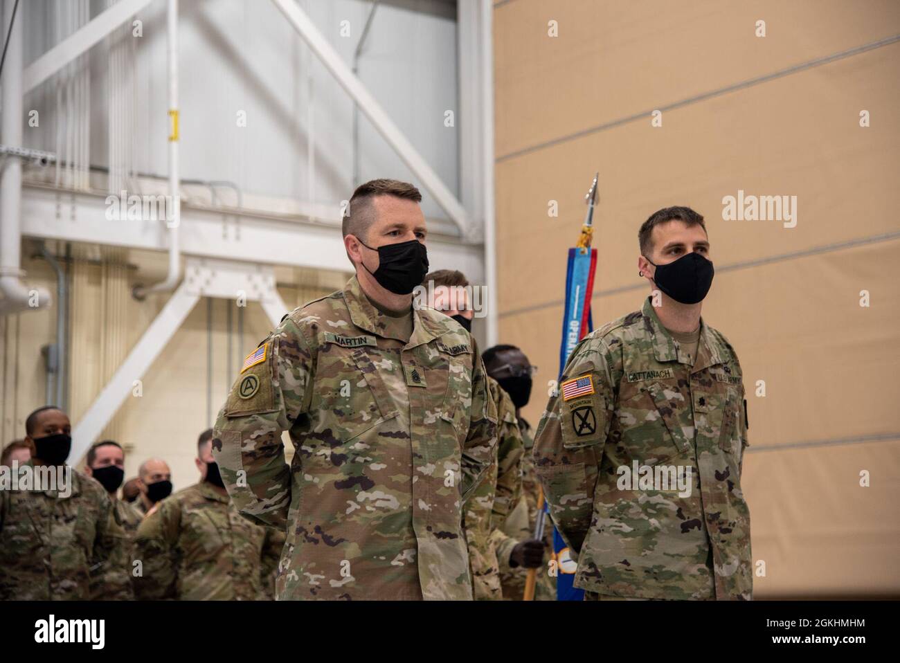 Command Sgt. Maj. John Martin and Lt. Col. Sean Cattanach, command team of HHC 1-169th Aviation Regiment, stand at parade rest in front of their formation during a sendoff ceremony in Windsor Locks, Conn. on April 25, 2021. The unit departed Connecticut that day for deployment to Kosovo. Stock Photo