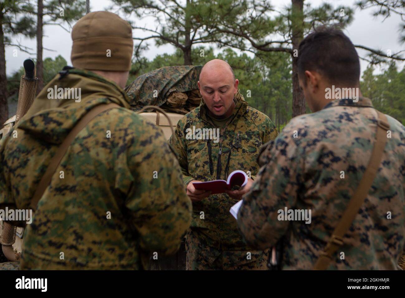 U.S. Marines with 1st Battalion, 10th Marine Regiment, 2d Marine Division (2d MARDIV), take part in a Sunday service during exercise Rolling Thunder 21.2 on Fort Bragg, N.C, April 25, 2021. This exercise is a 10th Marine Regiment-led live-fire artillery event that tests 10th Marines' abilities to operate in a simulated littoral environment against a peer threat in a dynamic and multi-domain scenario. Stock Photo