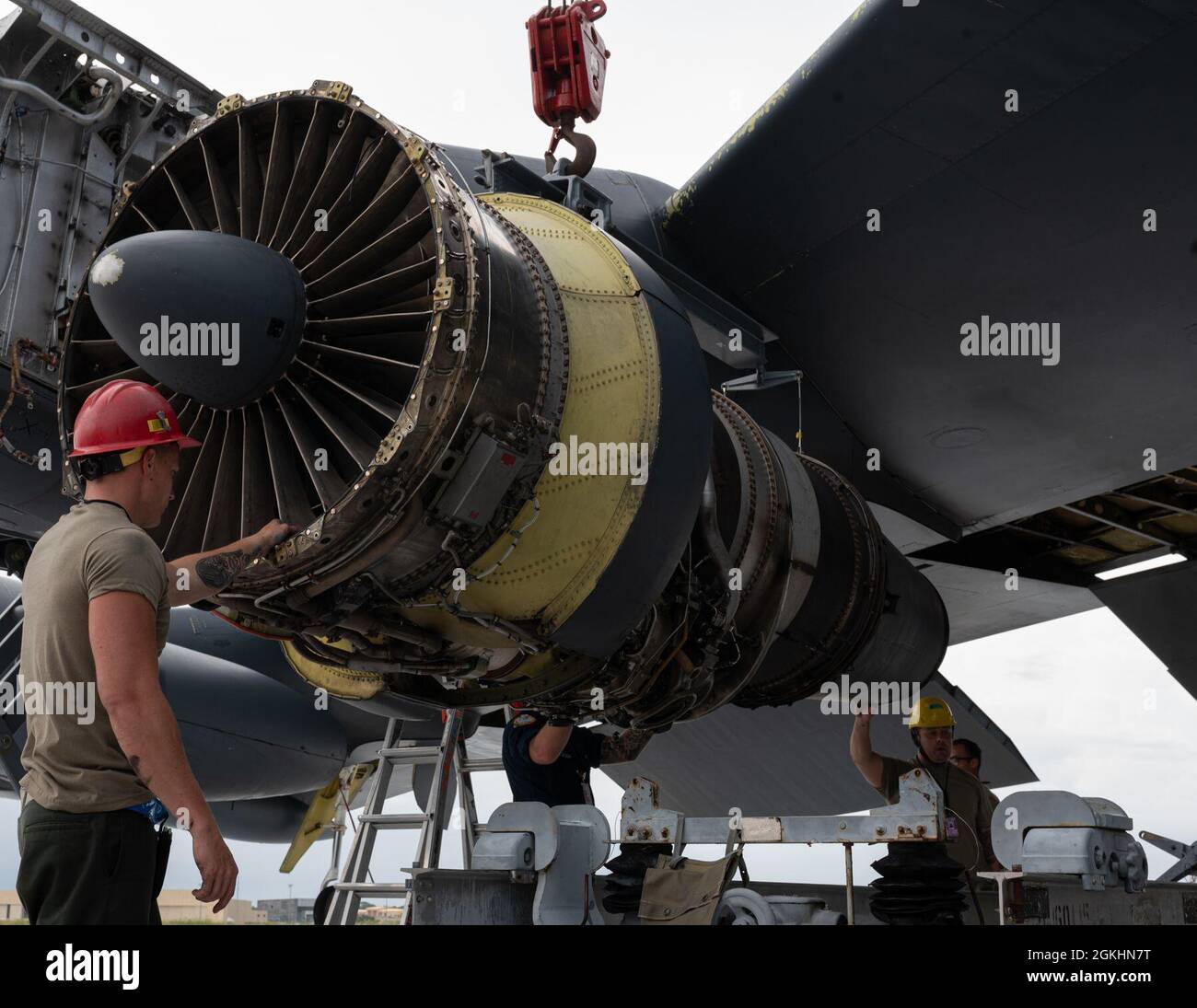 U.S. Air Force Airmen move an engine in order to repair it during a Bomber Task Force deployment at Andersen Air Force Base, Guam, April 25, 2021. U.S. Strategic Command units regularly conduct training with and in support of the Geographic Combatant Commands. USSTRATCOM Bomber Task Force missions help maintain global stability and security while enabling units to become familiar with operations in different regions. Stock Photo