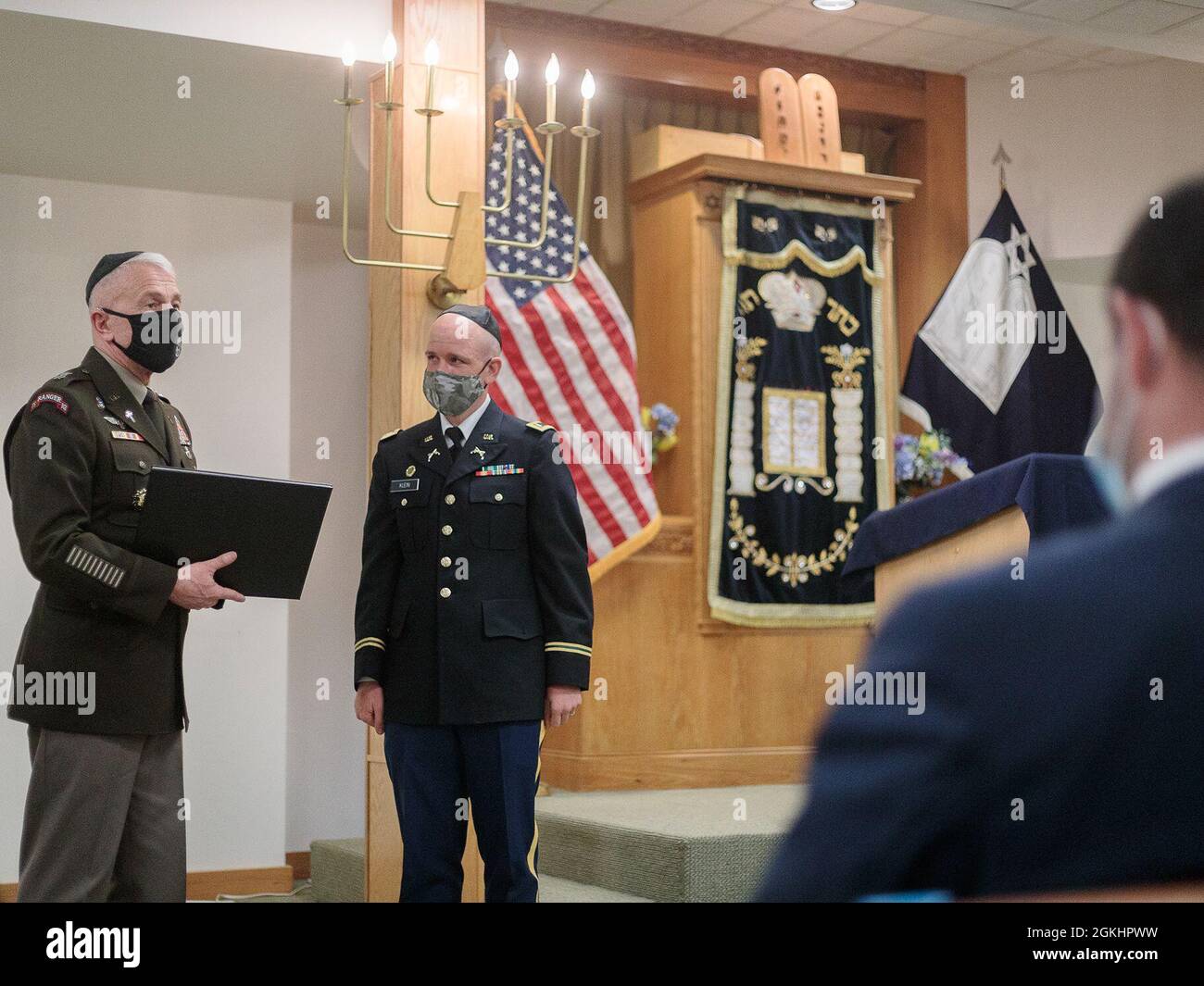 First Lt. Scott Klein, the Fort Bliss Jewish distinctive religious group leader, receives a commendation from Chaplain (Maj. Gen.) Thomas Solhjem, the U.S. Army Chief of Chaplains, at Chapel 3 at Fort Bliss, Texas, April 26, 2021. The dedication of the Torah scroll, the installation’s first in 20 years, marked the end of a three-month grassroots renovation progress for the synagogue, located at 1441 Pershing Road on west Bliss. Stock Photo