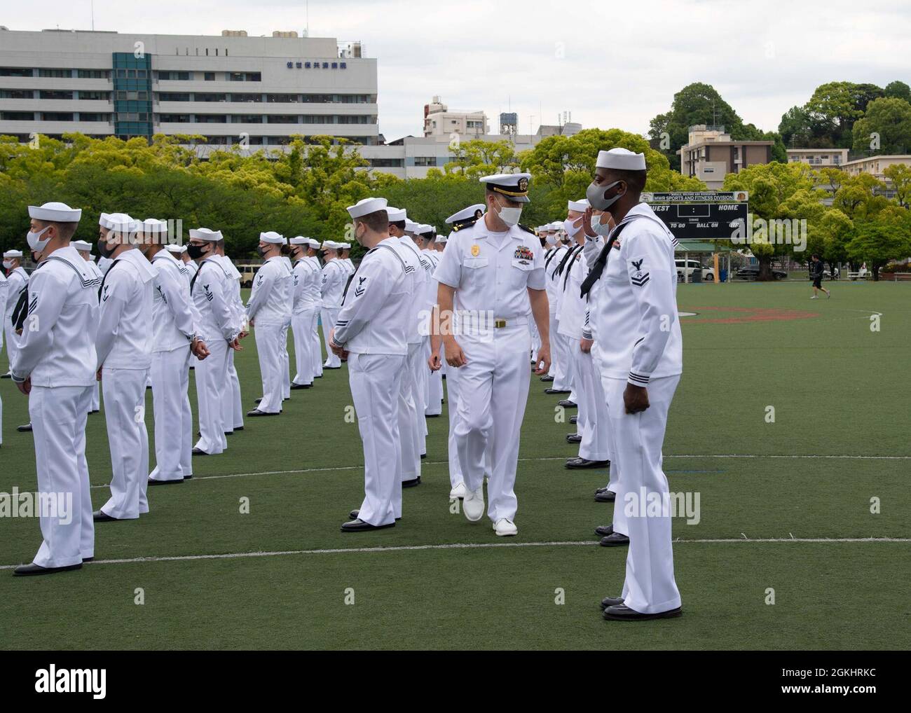 SASEBO, Japan (April 27, 2021) – Commander, Fleet Activities Sasebo’s Assistant Security Officer Ens. Zachery J. Bixby conducts a uniform inspection at Nimitz Park in Sasebo, Japan April 27, 2021. CFAS and other Commander, Navy Region Japan installations are scheduled to make the seasonal transition from service dress blues to service dress whites on May 1, 2021. Stock Photo