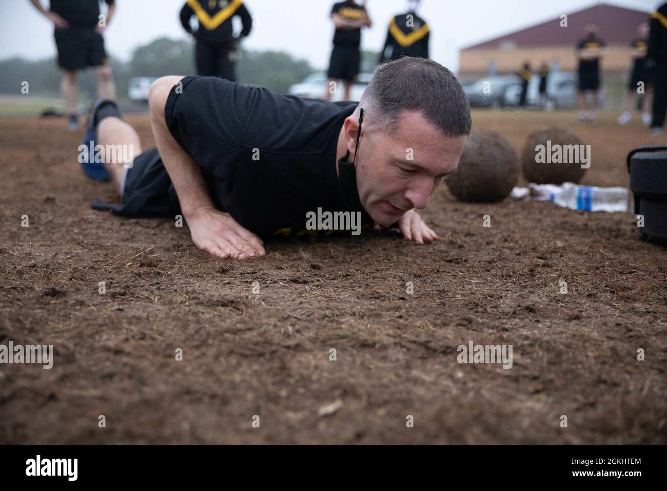 A U.S. Army Soldier with the Army Reserve Sustainment Command, attempts a hand-release push-up during a diagnostic Army Combat Fitness Test (ACFT) on Camp Bullis in San Antonio, Texas, April 27, 2021.  The ACFT is part of the Contracting Operational Readiness Exercise, which validates Soldiers through different events such as weapons qualification, Land Navigation, and other ancillary training. Stock Photo