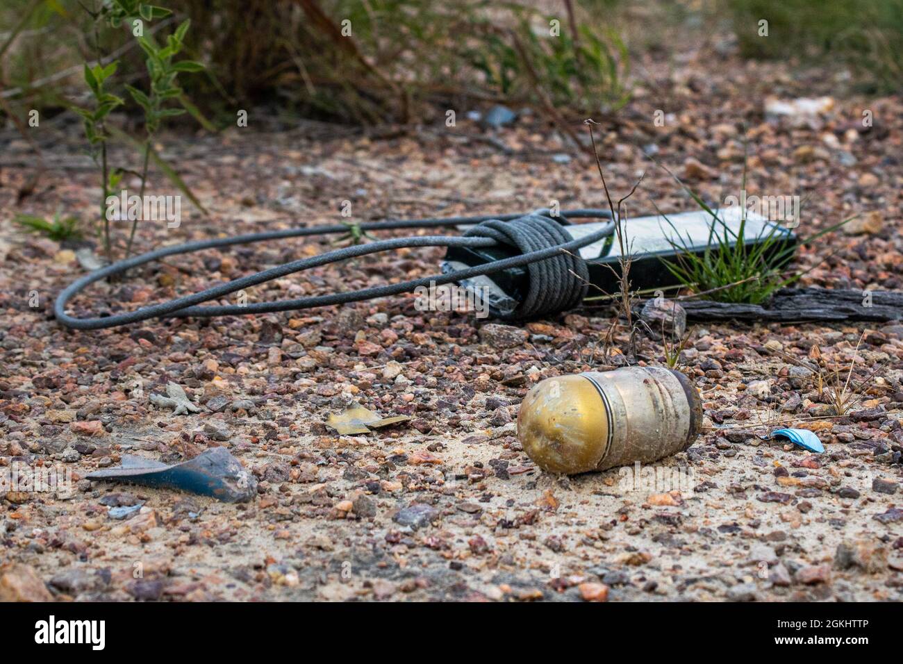 A plastic explosive wrapped in a time fuse and a 40 mm grenade lay on a