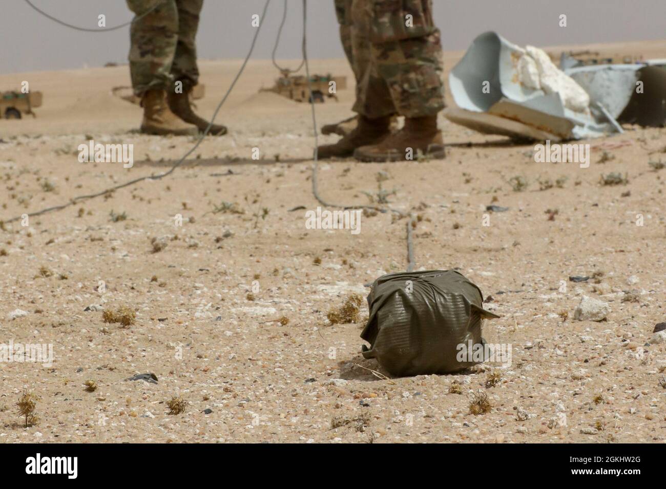 A block of C4 sits ready for detonation during 'Blow in Place' training with the 806th Engineer Company at the Udari Range, Kuwait, April 27. 2021. When dealing with improvised explosive devices,, Soldiers use robots to place explosives and detonate a detected device where it is buried and ‘blow it in place.’ Stock Photo