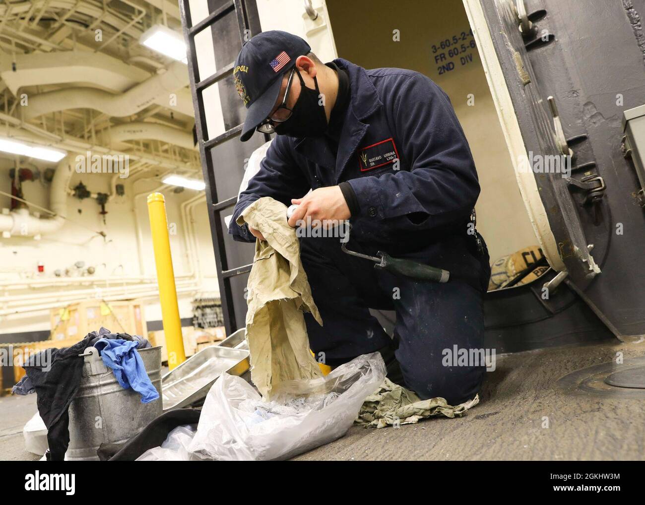 210427-N-TT639-1030 SAN DIEGO (April 27, 2021) Seaman Gustavo Urbina prepares painting supplies aboard the amphibious assault ship USS Tripoli (LHA 7), April 27. Tripoli is an America-class amphibious assault ship homeported in San Diego. Stock Photo