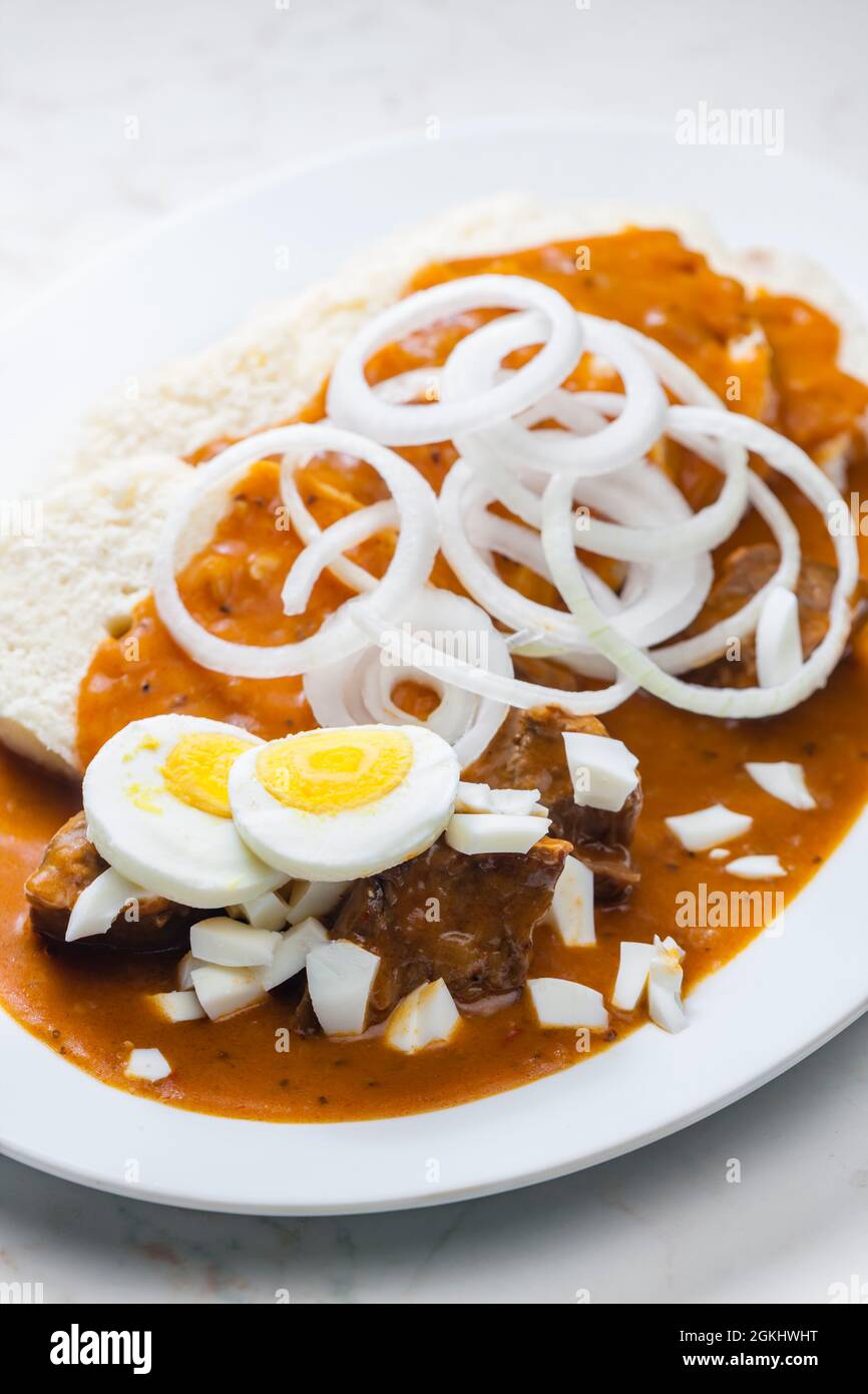beef goulash with onion rings, boiled egg and dumplings Stock Photo