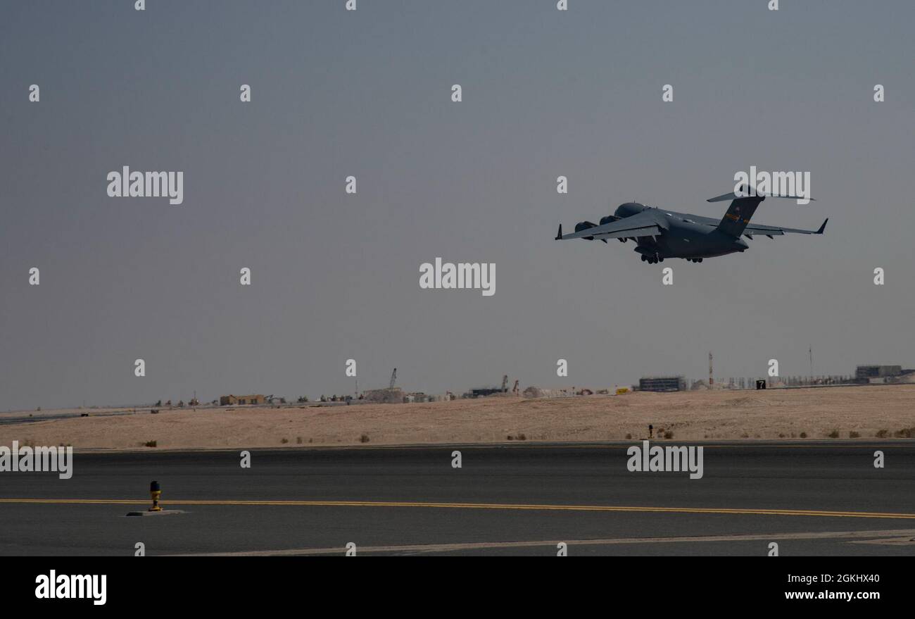 A C-17 Globemaster III assigned to Joint Base Charleston, South Carolina, takes off on the runway April 27, 2021, at Al Udeid Air Base, Qatar. U.S. Air Force C-17s and other mobility aircraft around the U.S. Air Forces Central theater are assisting with the safe and orderly drawdown operations from Afghanistan. Stock Photo