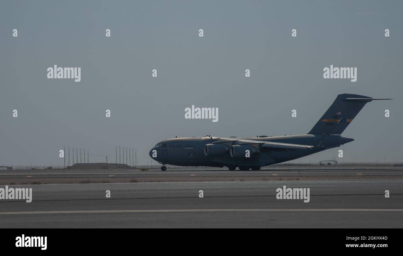 A C-17 Globemaster III assigned to Joint Base Charleston, South Carolina, prepares to takeoff on the runway April 27, 2021, at Al Udeid Air Base, Qatar. U.S. Air Force C-17s and other mobility aircraft around the U.S. Air Forces Central theater are assisting with the safe and orderly drawdown operations from Afghanistan. Stock Photo