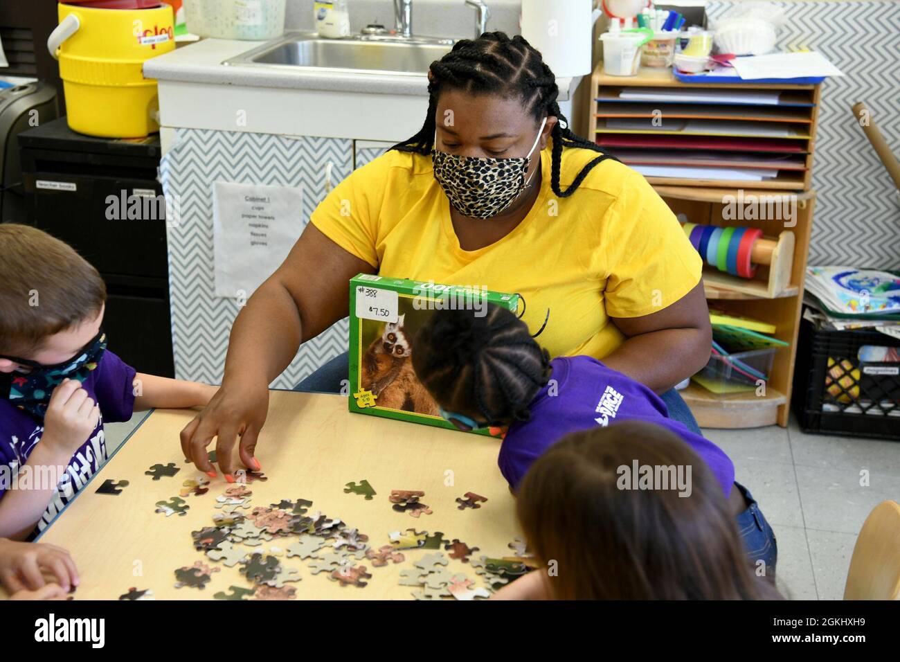 ROBINS AIR FORCE BASE, Ga. – LaKendra Jordan, 78th Force Support Squadron Child Development Center East pre-kindergarten teacher, helps students put a puzzle together during the class’s activity time at Robins Air Force Base, Georgia, April 27, 2021. The CDC and School Age Center provide care to children of military personnel in an enriched environment allowing their parents to focus on the mission needs of the Department of Defense. Stock Photo