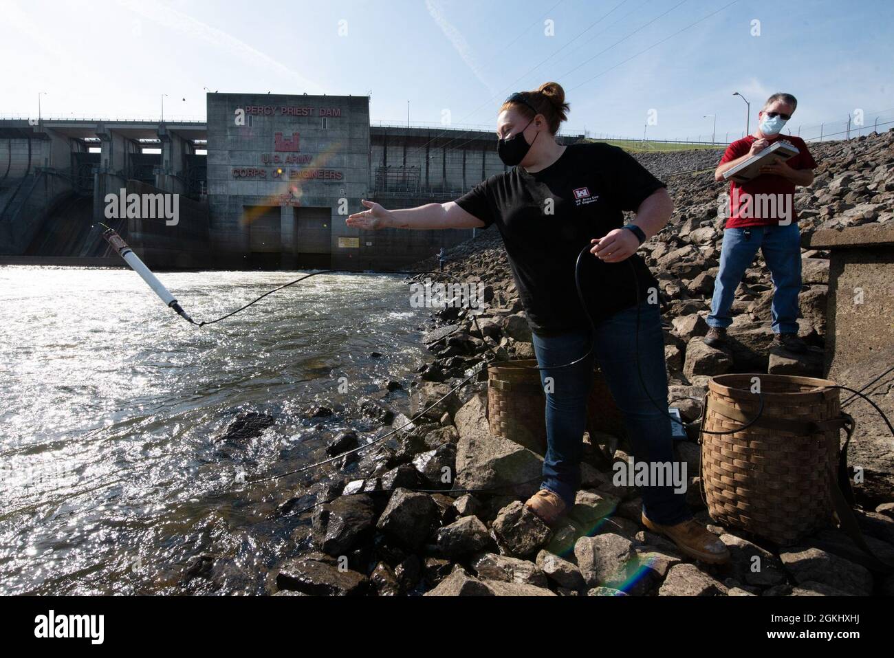 Sarah Pedrick, biologist in the U.S. Army Corps of Engineers Nashville District’s Water Management Section, and Mark Campbell, hydrologist, put a water quality instrument into the tailwater of the Stones River below J. Percy Priest Dam in Nashville, Tennessee April 27, 2021 while verifying the accuracy following recent calibrations. Stock Photo