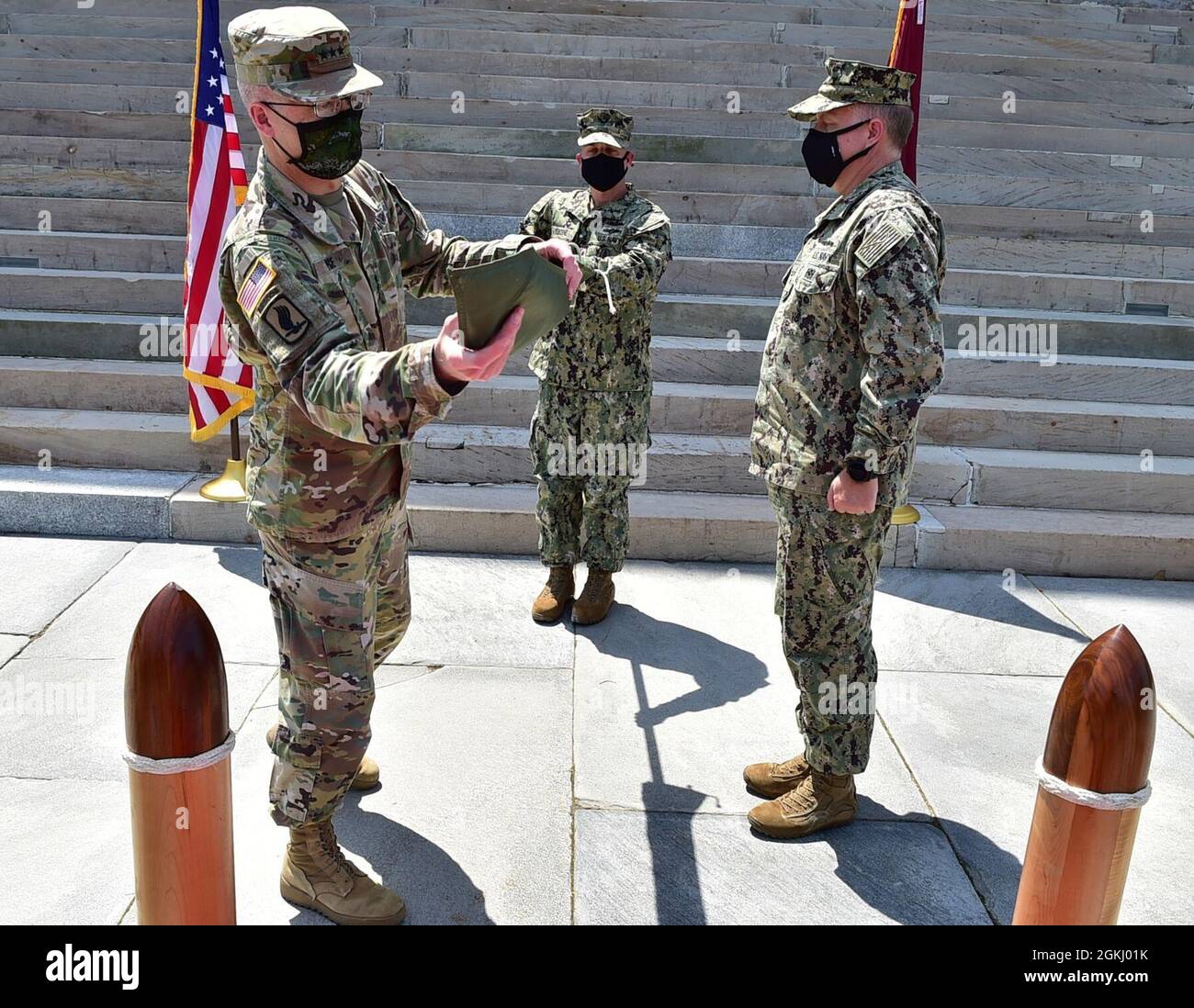 210428-N-TJ319-3724 PORTSMOUTH, Va. (April 28, 2021) - U.S. Army Lt. Gen. Ronald Place, director of the Defense Health Agency, left, and U.S. Navy Rear Adm. Darin K. Via, director of the Tidewater Market, and commander, Naval Medical Forces Atlantic, unfurl the Defense Health Agency flag during a socially distanced establishment ceremony to mark the standup of the Tidewater Market, April 28, 2021. Tidewater Market is on the leading edge of the Military Health System’s historic change, following its certification by the Defense Health Agency on April 19, 2021. Stock Photo