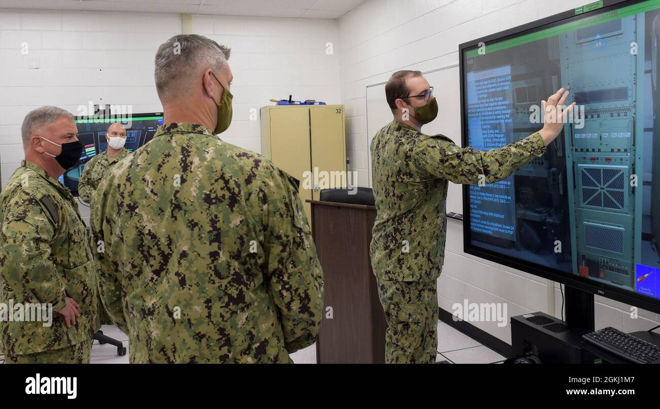 210428-N-KJ380-1046 PENSACOLA, Fla. (April 28, 2021) - Chief of Naval Personnel Vice Adm. John B. Nowell Jr. (far left)  participates in a Multipurpose Reconfigurable Training System 3D® (MRTS 3D®) technology training device demonstration and discussion with staff at the Center for Information Warfare Training and Information Warfare Training Command (IWTC) Corry Station. Nowell, along with Fleet Master Chief Wes Koshoffer, visited for a familiarization brief and tour of CIWT and IWTC Corry Station onboard Naval Air Station Pensacola Corry Station, Pensacola, Florida. The visit offered an oppo Stock Photo