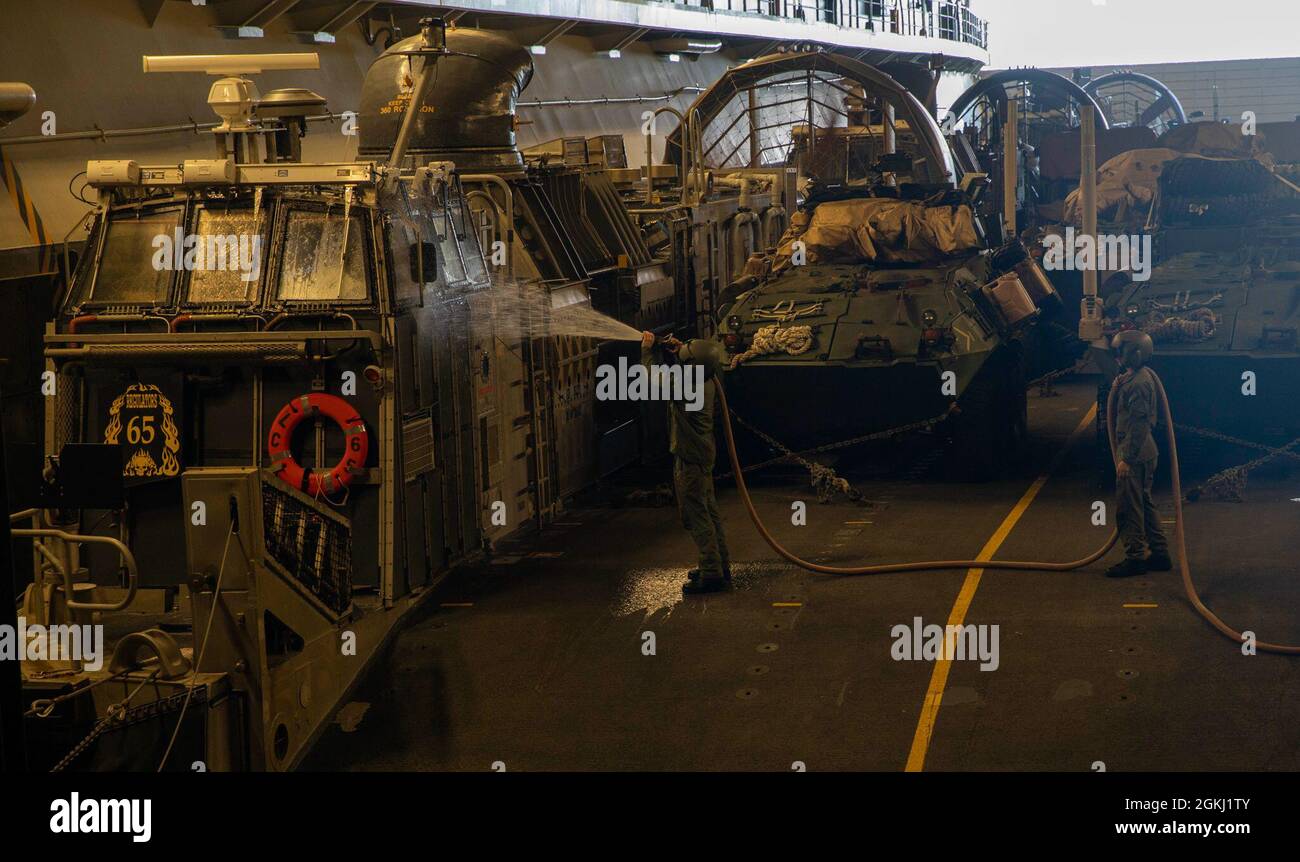 PACIFIC OCEAN (April 27, 2021) – U.S. Navy Boatswain's Mate 2nd Class  Jayden Otto, left, and Gas Turbine System Technician (Mechanical) 3rd class  Collin Dowdy, assigned to Assault Craft Unit 5, conduct