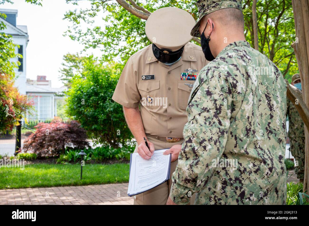 WASHINGTON, DC (April 28, 2021) – Senior Chief Culinary Specialist Korhy Flanary signs paperwork following a reenlistment ceremony held onboard Washington Navy Yard. Stock Photo