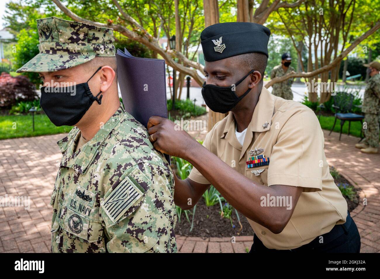 WASHINGTON, DC (April 28, 2021) – Culinary Specialist 1st Class Gideon Ige signs paperwork following a reenlistment ceremony held onboard Washington Navy Yard. Stock Photo