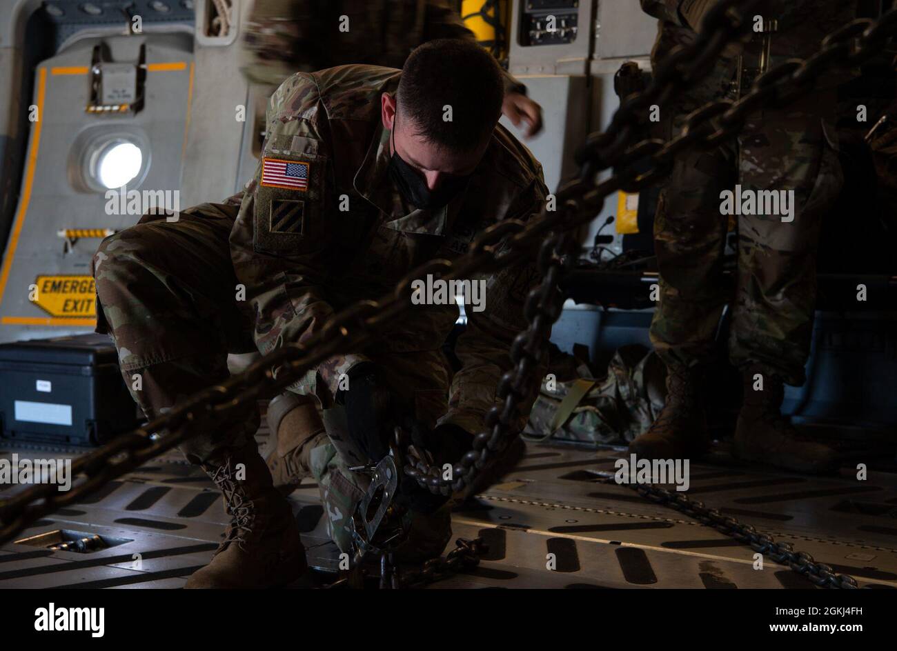 A U.S. Soldier secures a High Mobility Artillery Rocket System to a C ...
