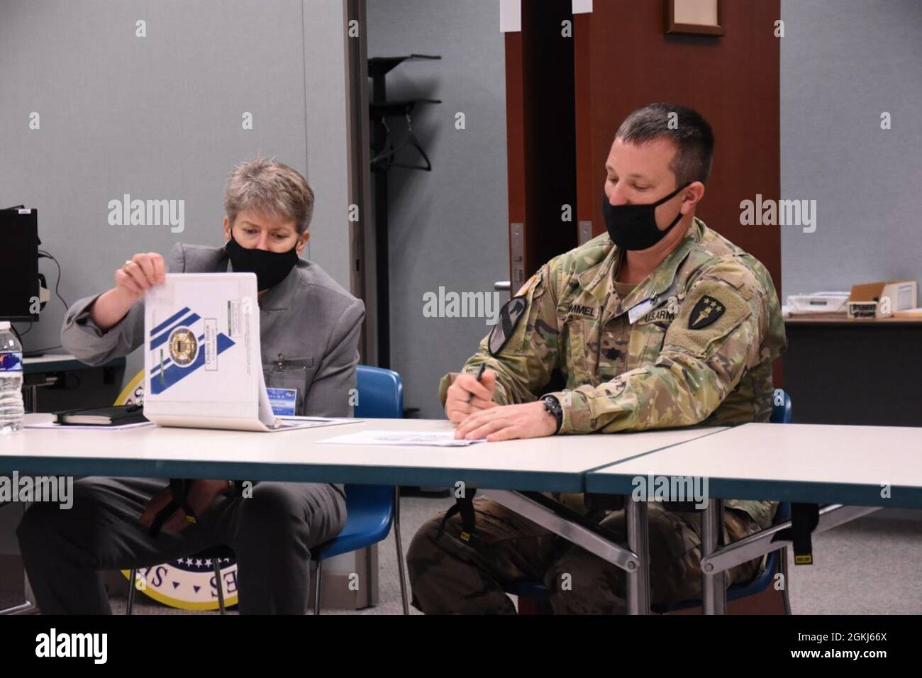 Roleplaying the Secretary of Defense, COL Stacy Tomic (left) receives a SECDEF Orders Book briefing from Army Lt. Col. Brian Hummel, as Student J35 Global Force Manager. Stock Photo