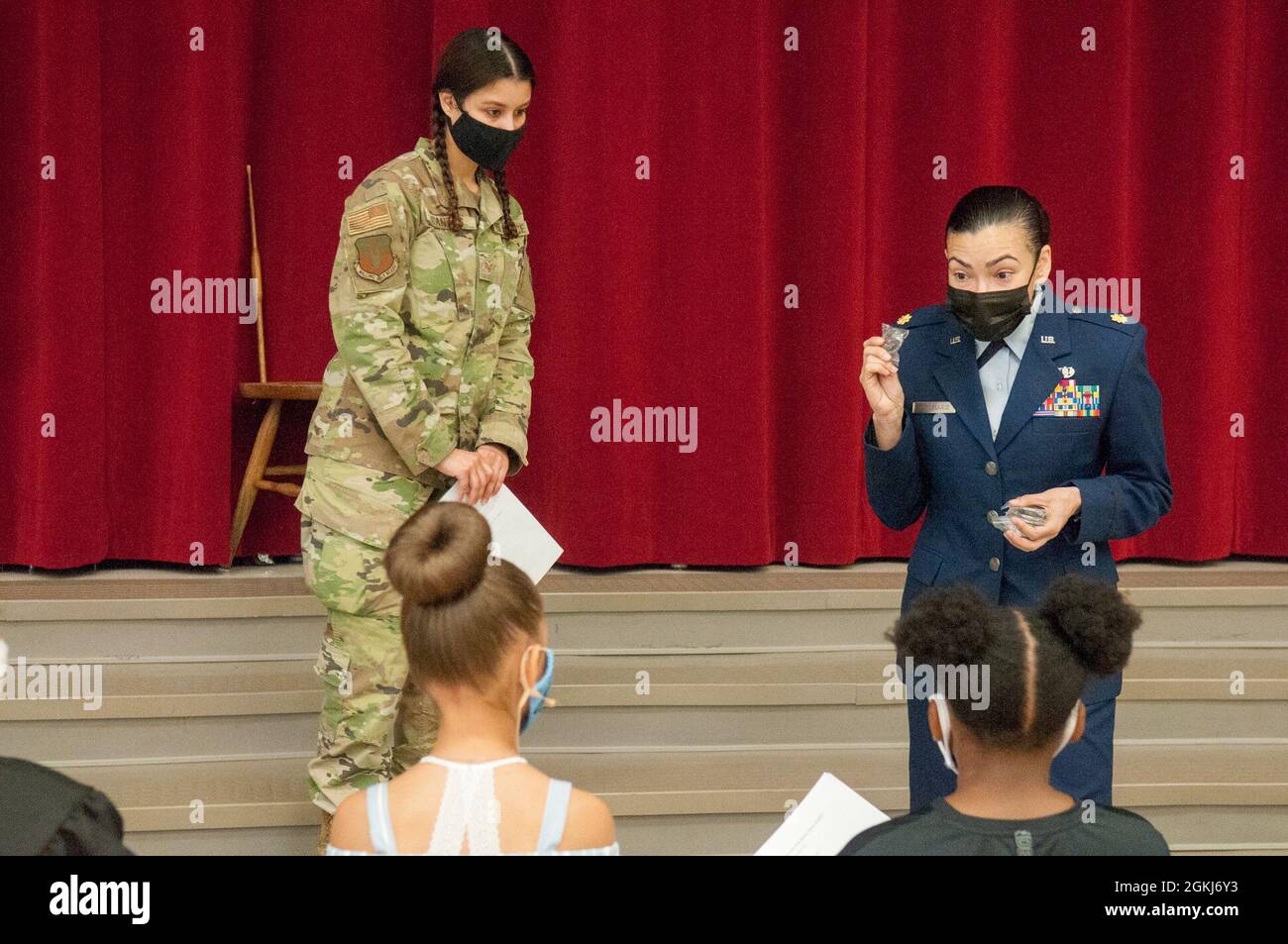 Staff Sgt. Olivia Cantos (left) and Major Jasmine Candelario (right) thank student's that participated in the mock trial with challenge coins as a part of Law Day, 29 April 2021, at Irwin Intermediate School, Fort Bragg, NC. Students simulated a trial acting as judge, jury, lawyer, and more, all while learning about the judicial process. Stock Photo