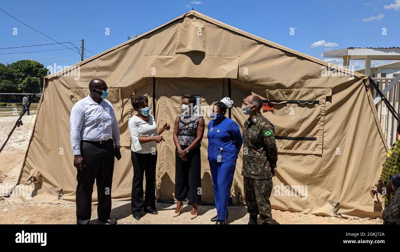 Brig. Gen. Alcides V. Faria, right, U.S. Army South deputy commanding general for interoperability, receives a tour by representatives of the Ministry of Health and Wellness of a U.S.-funded mobile field hospital based at the Spanish Town Hospital in St. Catherine, Jamaica, April 29, 2021. Stock Photo