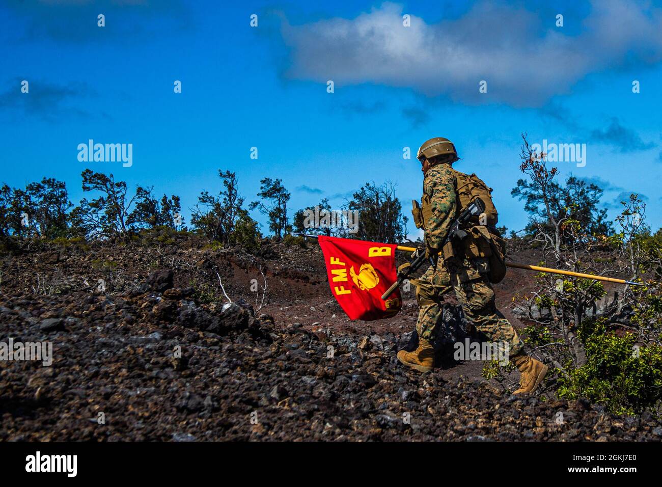 U.S. Marine Corps Lance Cpl. Clarence Walker, rifleman, 1st Battalion, 3d Marines, carries the company guidon down range during exercise Bougainville II at Pohakuloa Training Area, Hawaii, April 29, 2021. Bougainville II is the second phase of pre-deployment training conducted by the battalion designed to increase combat readiness through complex and realistic live-fire training. Stock Photo