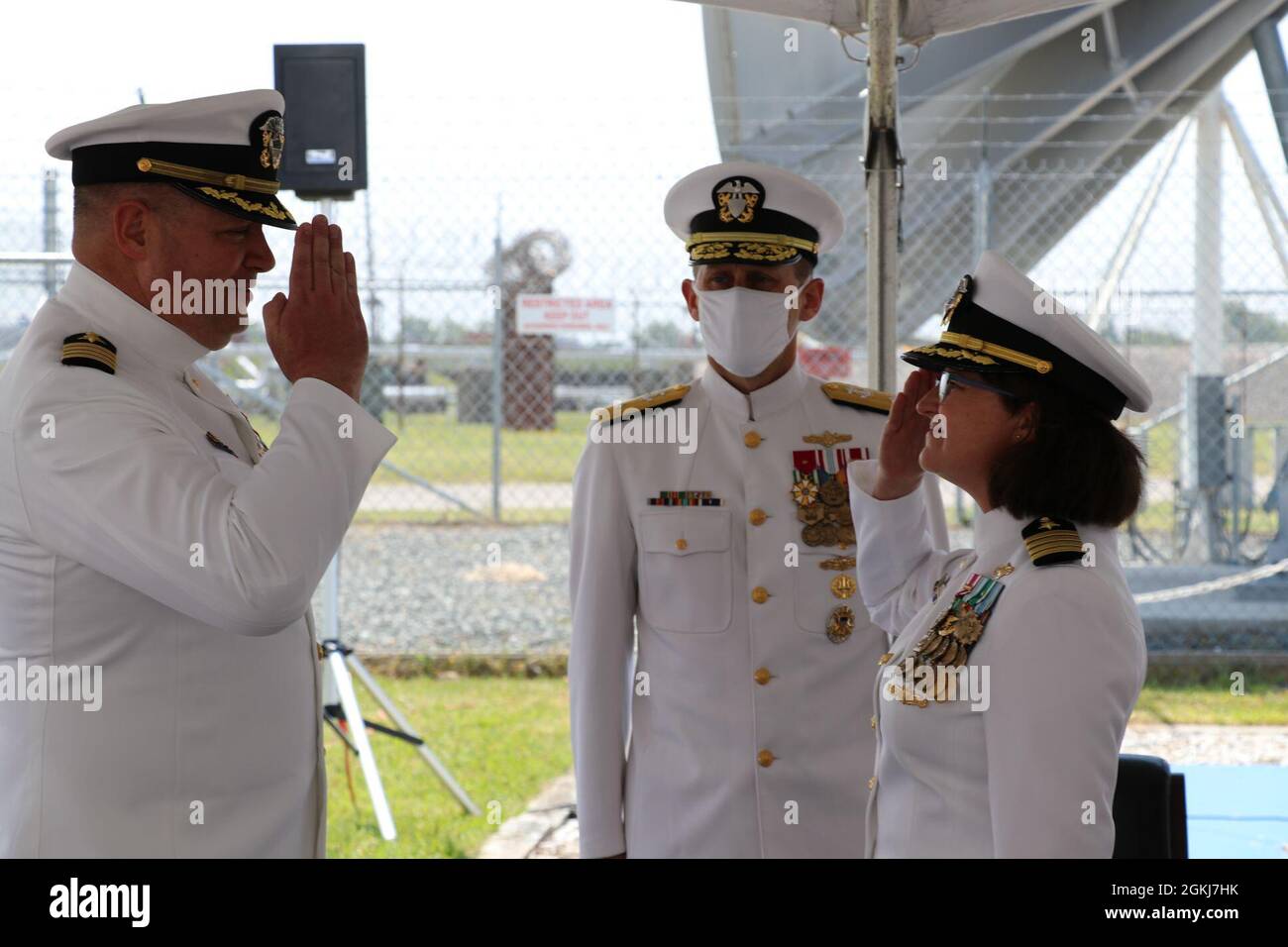 Capt. Chris Gabriel (left) salutes Capt. Erin Acosta (right) in the relinquishment of all duties and responsibilities as Commanding Officer of FWC-N, during a change of command ceremony presided by Rear Adm. John A. Okon at Naval Station Norfolk, Virginia on Apr 29, 2021. Stock Photo