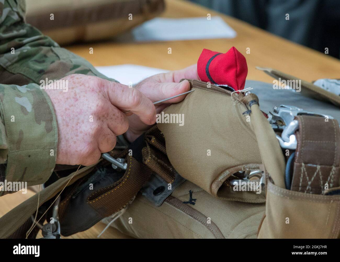 Tech. Sgt. Ronald Patton, aircrew flight equipment technician for the 403rd Operations Support Squadron at Keesler Air Force Base, Miss., reinforces a BA-30 Low Profile Parachute system April 29, 2021. Patton repairs flight equipment to ensure it is safe to use in the event of an in-flight emergency. Stock Photo