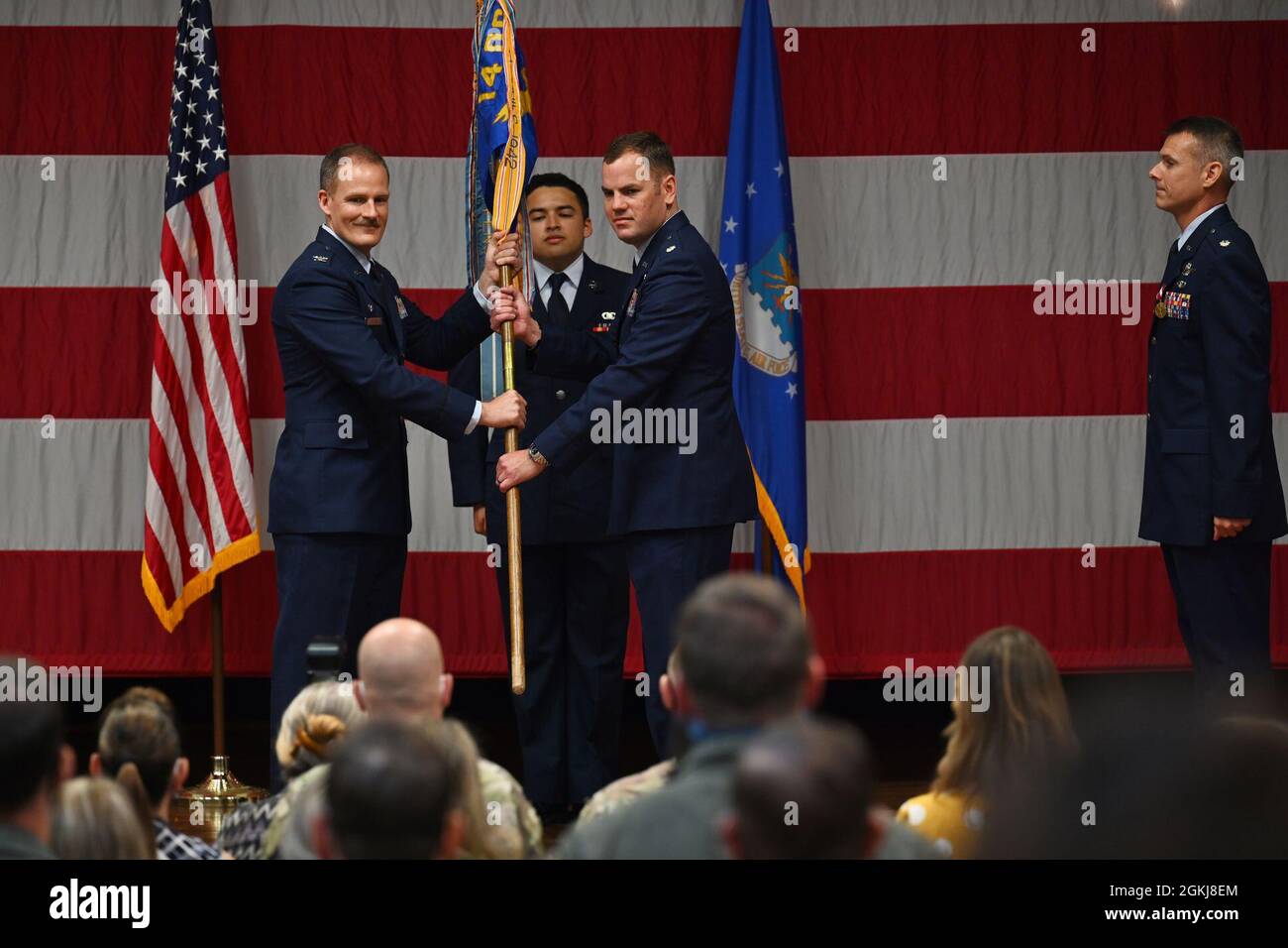 Col. Justin Spears, 14th Operations Group commander, hands Lt. Col. Paul Anderson, 50th Flying Training Squadron commander, the 50th FTS guidon at the 50th FTS change of command ceremony, April 30, 2021, on Columbus Air Force Base, Miss. The advanced phase of undergraduate pilot training is conducted by the 50th FTS where students fly the T-38C Talon trainer aircraft. Stock Photo