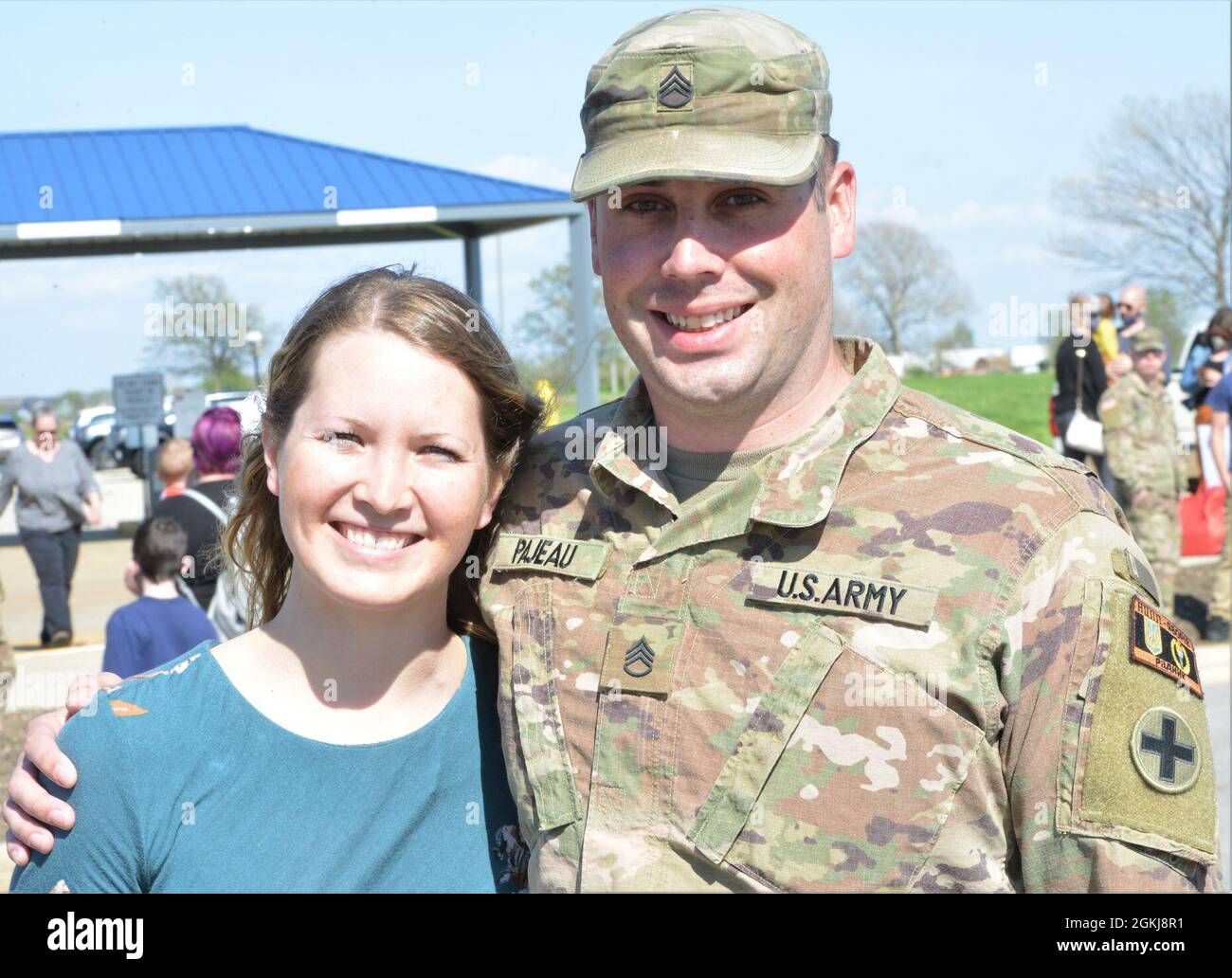 Capt. Amy Pajeau (left) and her husband, Staff Sgt. Benjamin Pajeau, are re-united after more than 15 months apart. The couple faced back-to-back deployments with Capt. Pajeau deploying prior to her husband, who returned Friday, April 30. About 165 Illinois Army National Guard Soldiers returned April 30 to Illinois after an 11-month deployment to Ukraine where the unit formed “Task Force Illini” as the command element of Joint Multinational Training Group-Ukraine, which is responsible for training, advising and mentoring the Ukrainian cadre at Combat Training Center-Yavoriv, Ukraine to improve Stock Photo