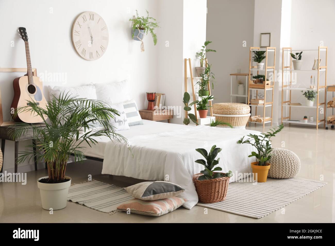 Interior of stylish bedroom with plants Stock Photo - Alamy
