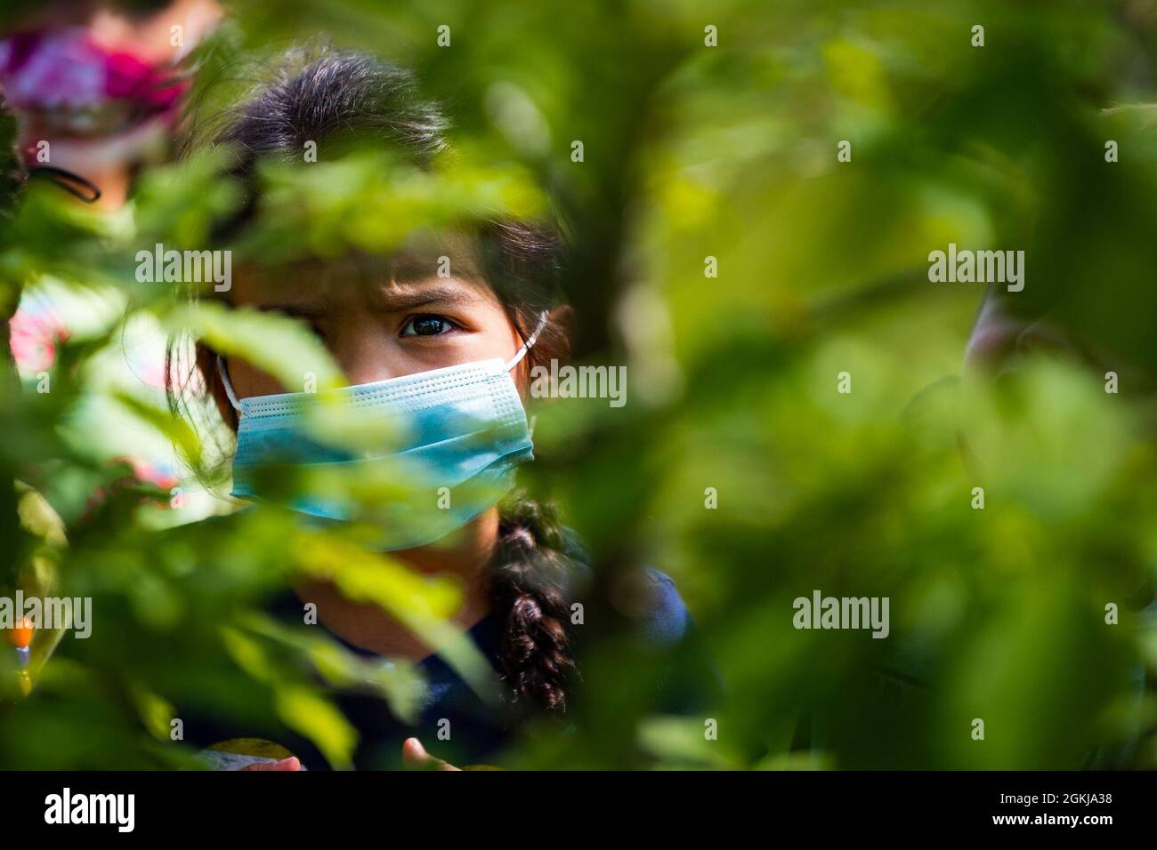 Riley Wells, child of U.S. Air Force Tech. Sgt. Dayna Wells, observes a swamp chestnut oak tree after a tree planting event at Moody Air Force Base, Georgia, April 30, 2021. The 23d CES invited students from the Child Development Center to help plant a swamp chestnut oak tree in a small grove on base. Stock Photo