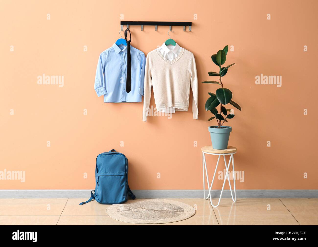 Stylish school uniform hanging on color wall Stock Photo Alamy