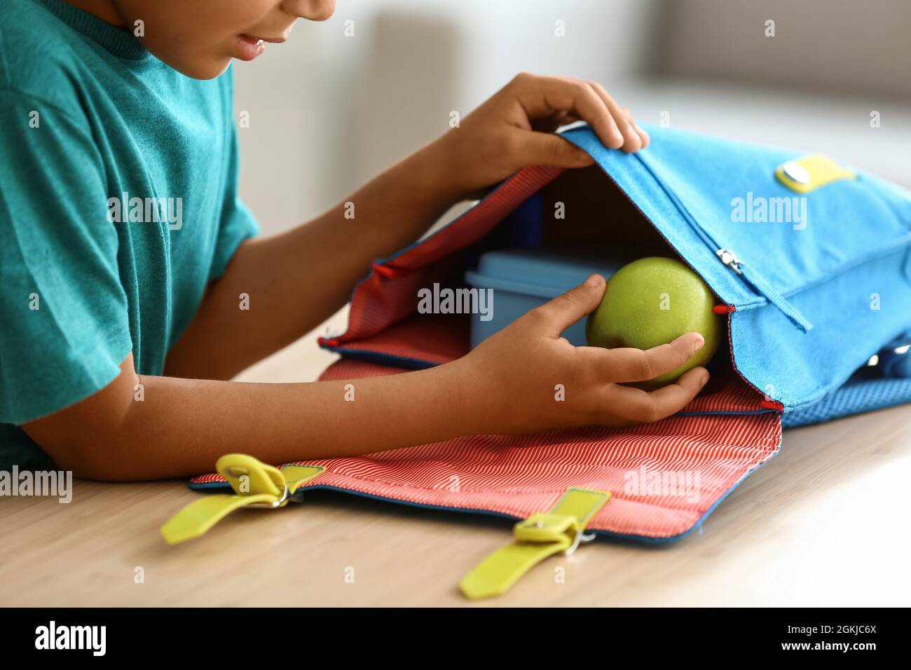 Cute little boy putting his school lunch in bag Stock Photo