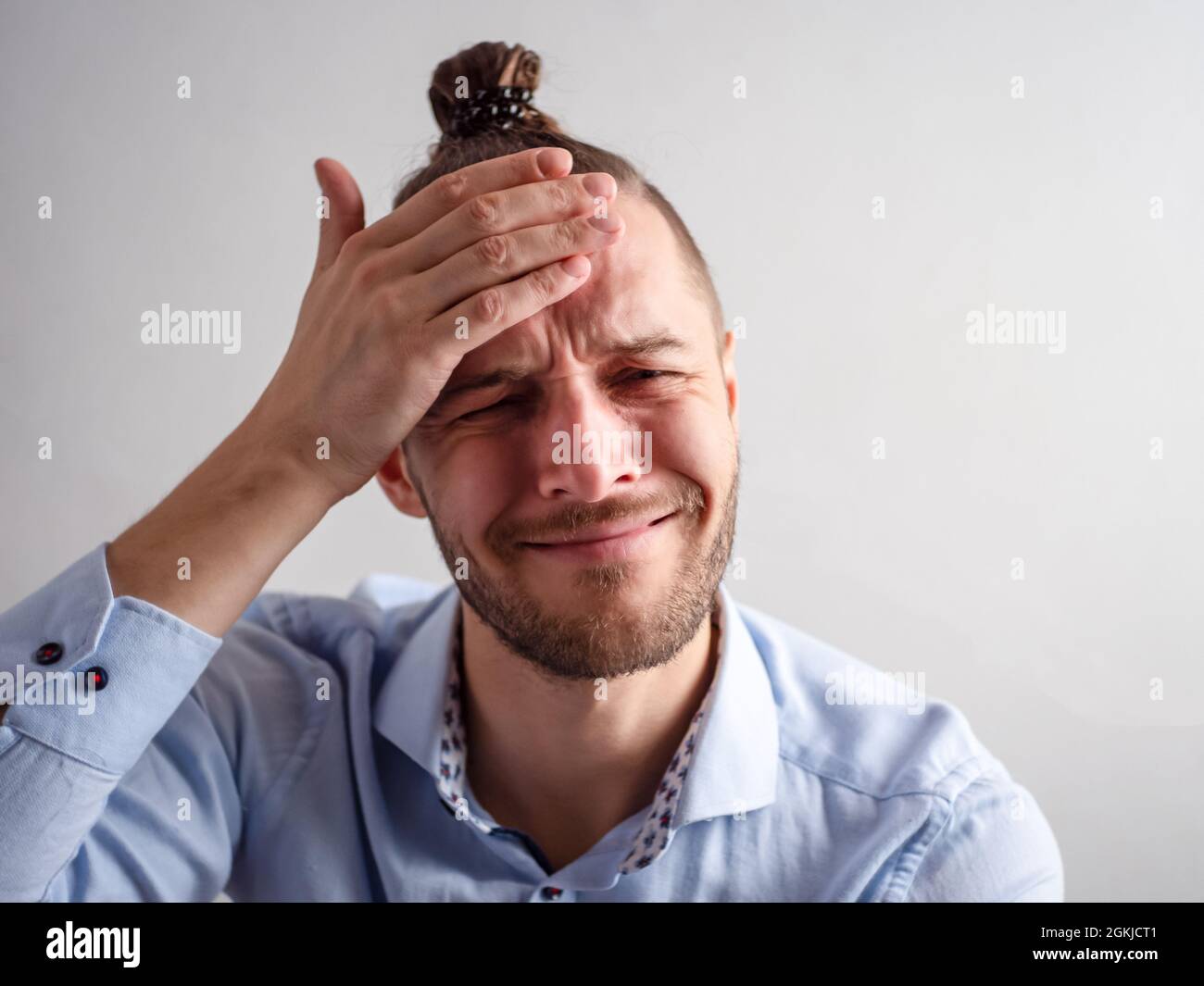 White Young Man Looks Like he Forgot to do Something and Slaps his Forehead with the Palm of his Hand Stock Photo