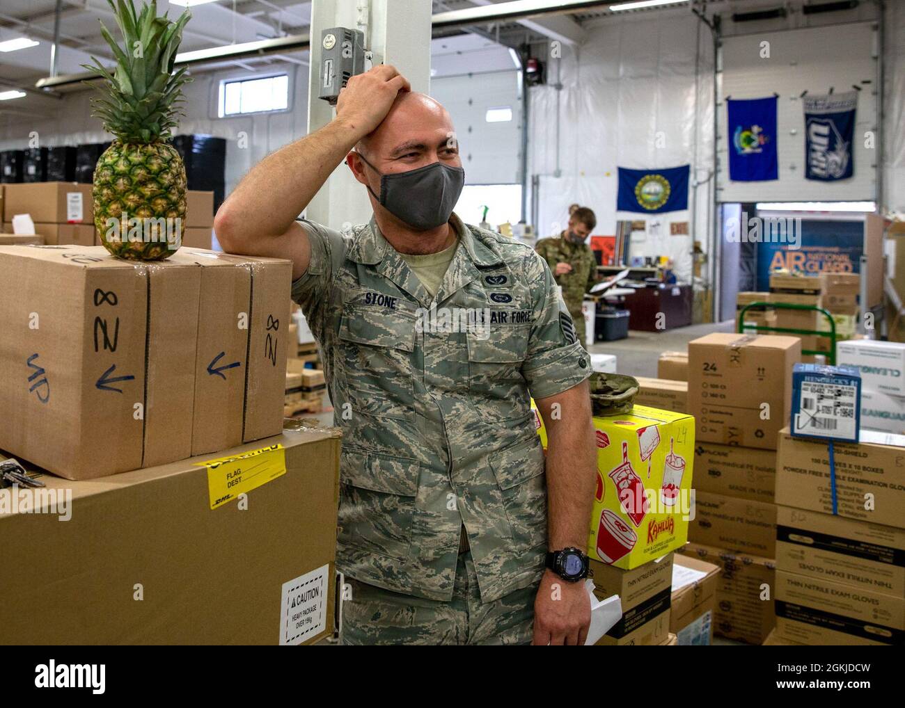 Staff Sgt. Dexter Stone of Task Force Distro, 157th Air Refueling Wing, New Hampshire National Guard, shares a laugh will fellow Airmen March 31, 2021, at a PPE warehouse in Concord, N.H. Stone and his peers wore the Airman Battle Uniform (ABU) to work one last time before they are officially replaced by newer Operational Camouflage Pattern (OCP) issue April 1. Though receptive of the change, Stone said he will miss rolling up his ABU sleeves in the summer, which is hindered by the OCPs thick upper-sleeve pockets and patches. Stock Photo