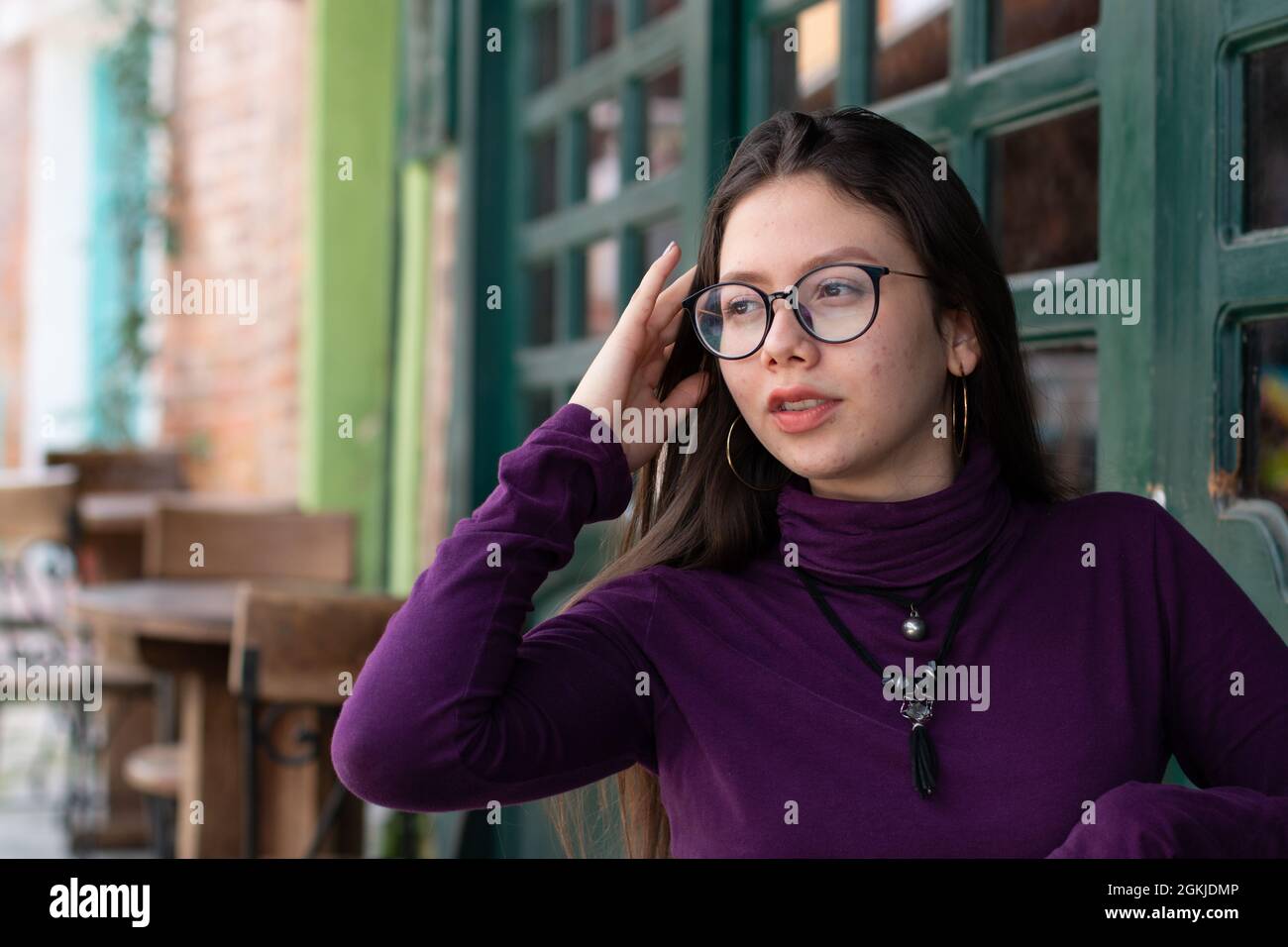 Teenager with acen posing confidently in urban street. Concept of awkward years. Stock Photo