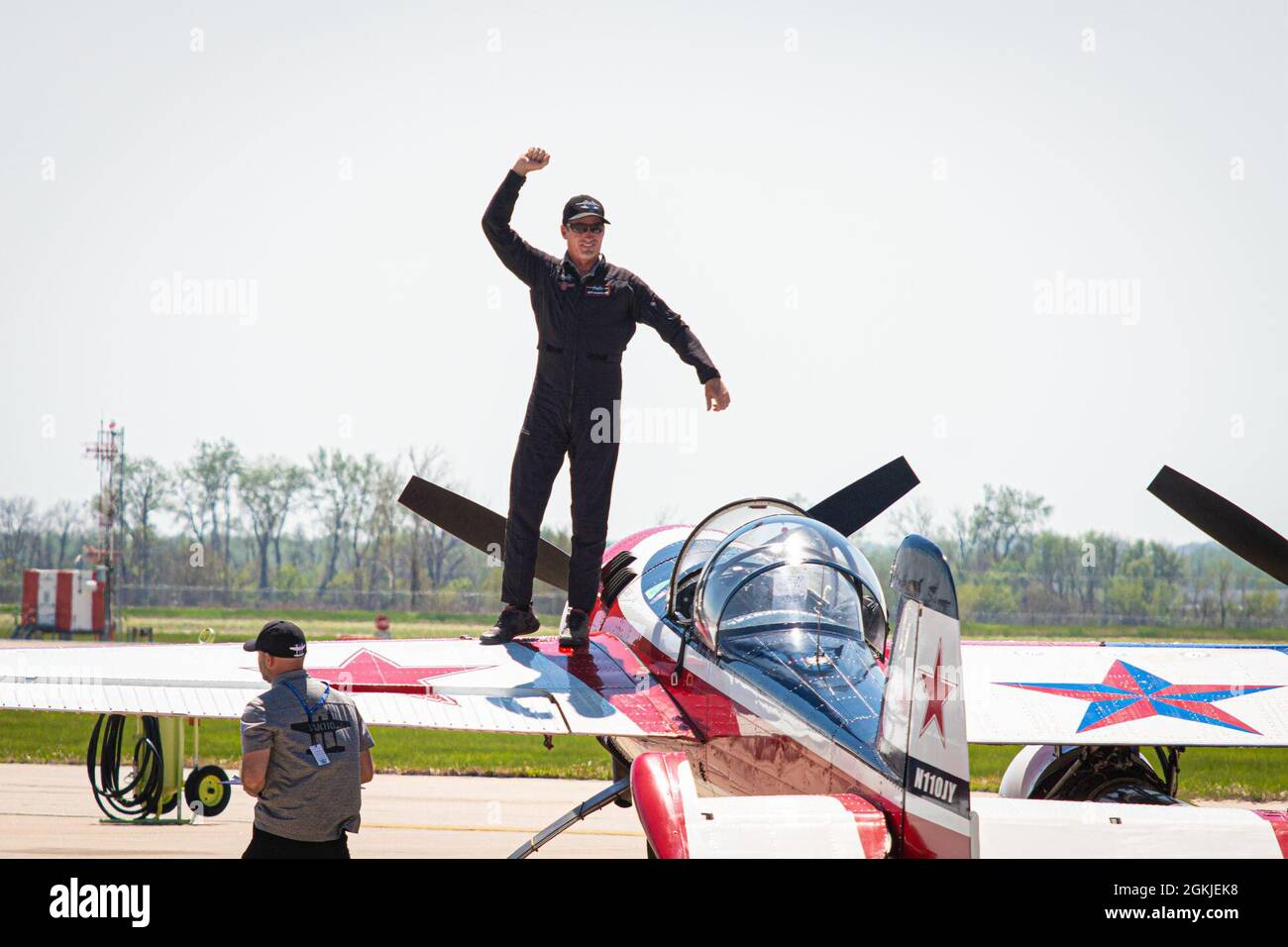 Jeff Boerboon stands on his YAK-110 aircraft and waves to the crowd during the Speed of Sound Airshow at Rosecrans Memorial Airport in St. Joseph, Missouri, May 1, 2021. The Yak-110 is two Yak-55 aircraft connected together with a J-85 jet engine welded to the bottom. The air show was hosted by the 139th Airlift Wing, and city of St. Joseph to thank the community for their support. The air show committee estimated around 30,000 people attended during the weekend performances in which the United States Air Force Thunderbirds Air Demonstration Squadron were featured. Stock Photo
