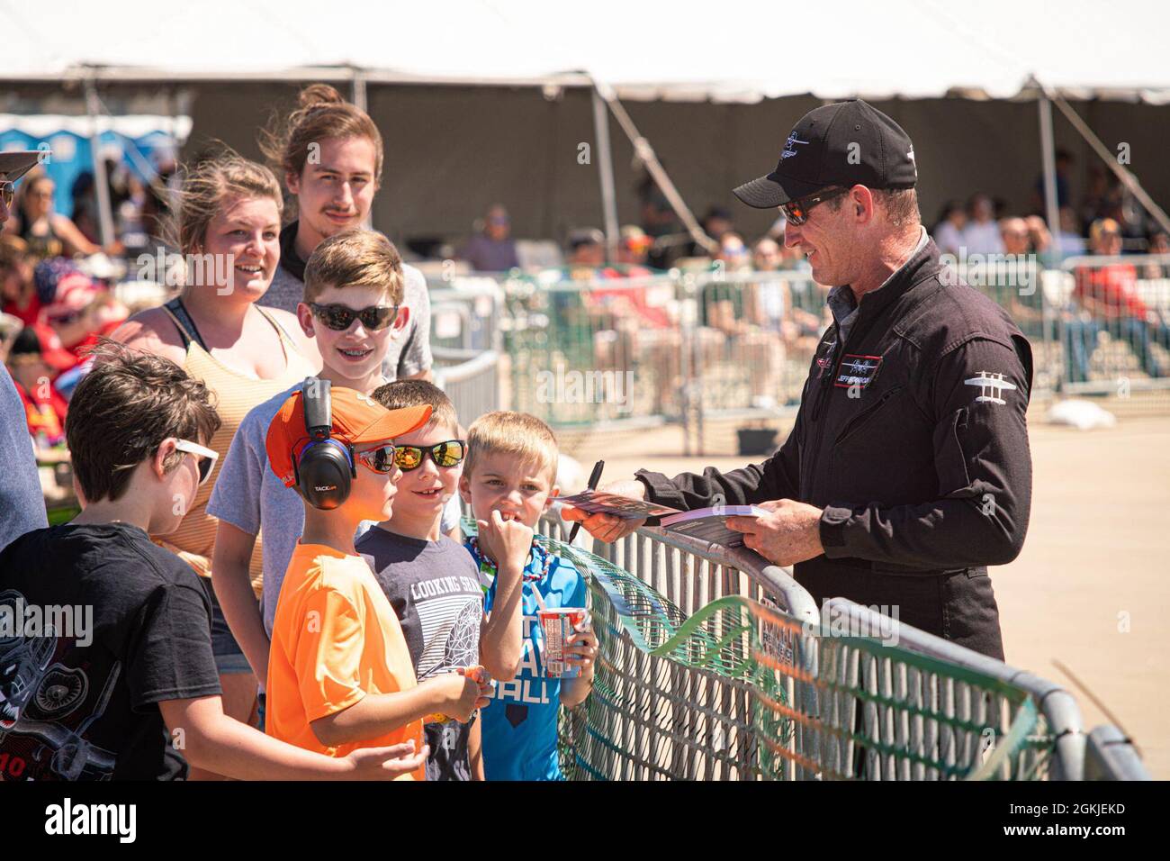 Jeff Boerboon, the pilot of the YAK-110 aircraft signs autographs after his performance at the Speed of Sound Airshow at Rosecrans Memorial Airport in St. Joseph, Missouri, May 1, 2021. The Yak-110 is two Yak-55 aircraft connected together with a J-85 jet engine welded to the bottom. The air show was hosted by the 139th Airlift Wing, and city of St. Joseph to thank the community for their support. The air show committee estimated around 30,000 people attended during the weekend performances in which the United States Air Force Thunderbirds Air Demonstration Squadron were featured. Stock Photo